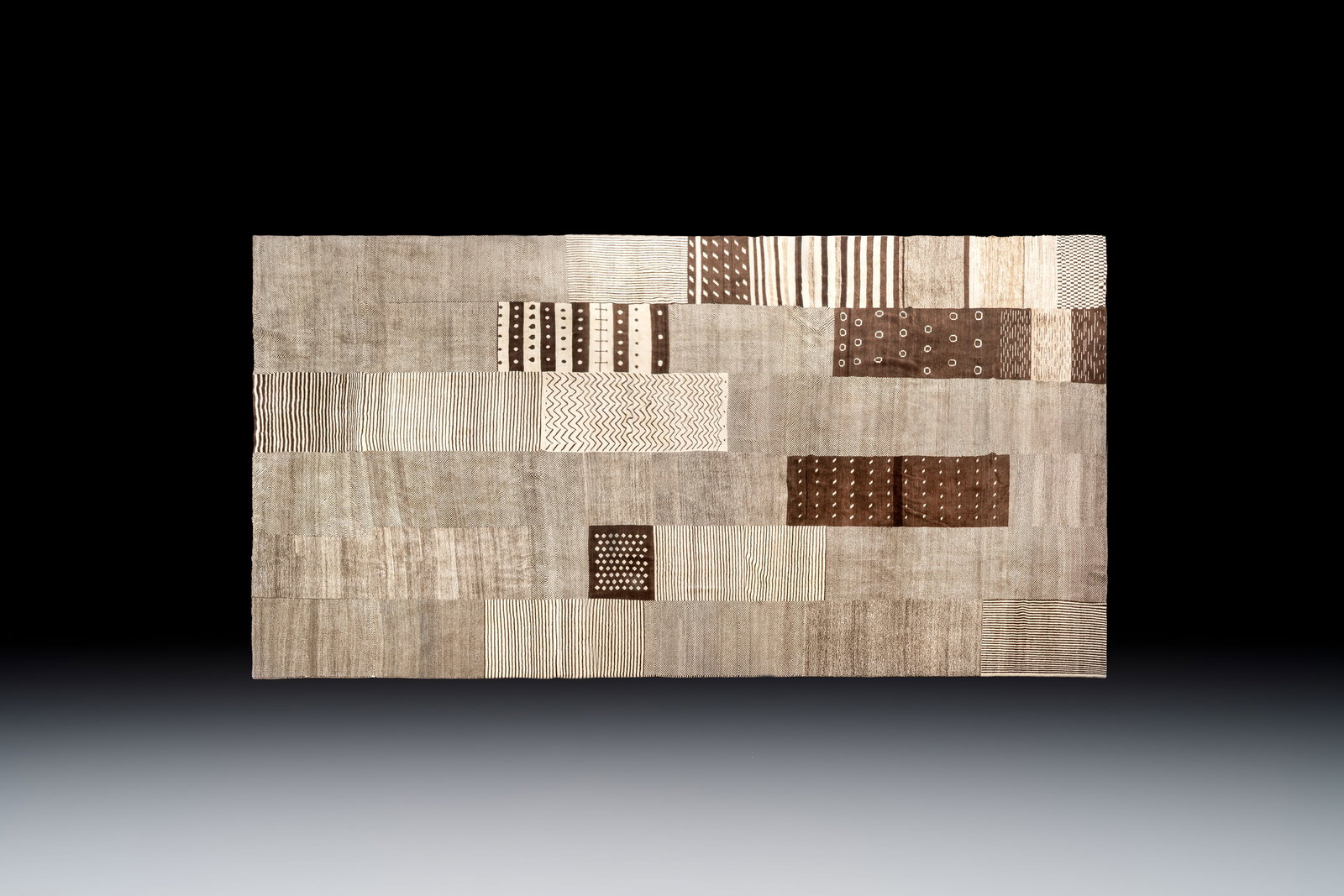 A very large Persian hand-knotted wool carpet with a geometric patchwork design, 20th C. (1 of 4)