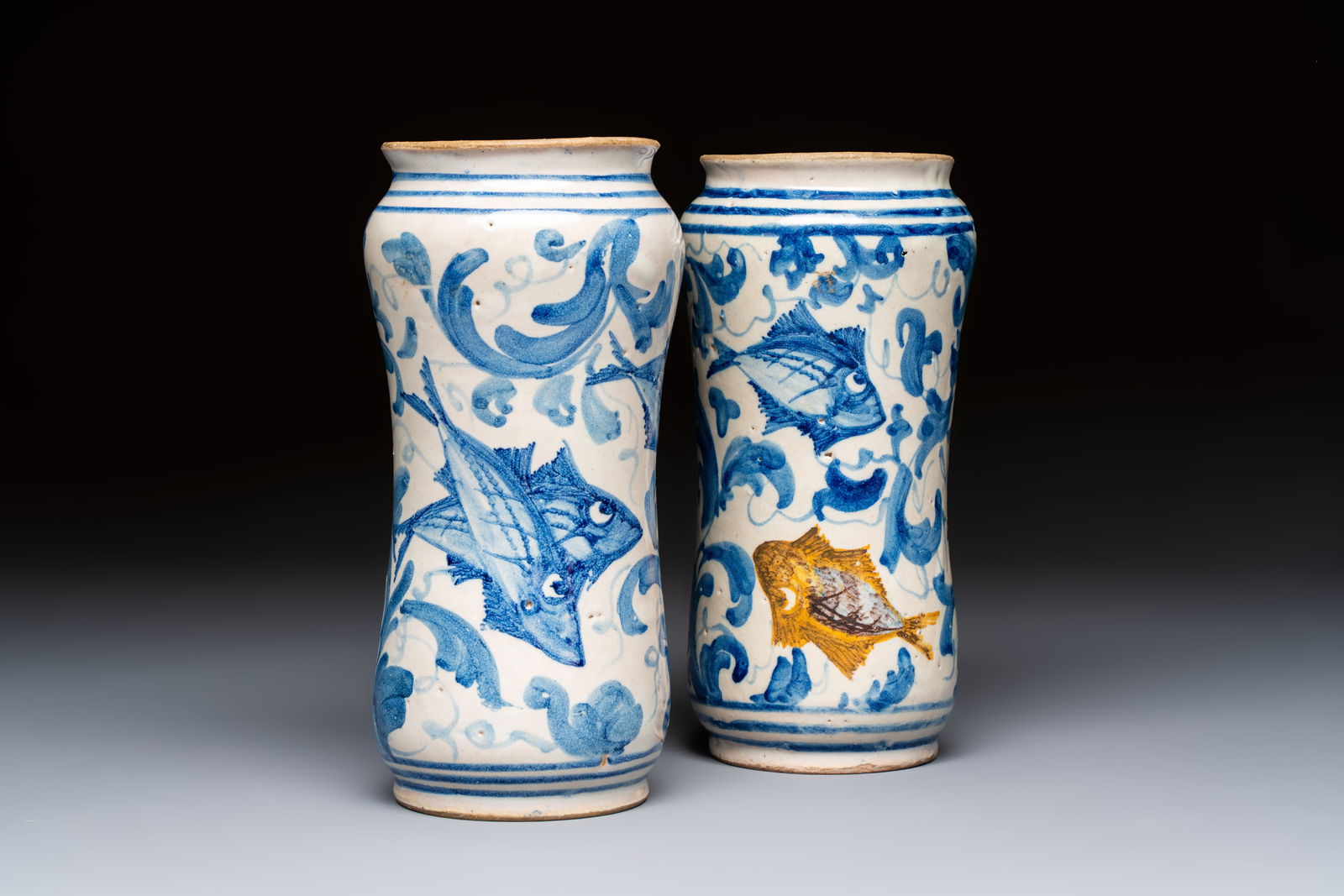 A pair of unusual blue, white and polychrome Italian maiolica 'fish' albarelli, 18th C.: A pair of unusual blue, white and polychrome Italian maiolica 'fish' albarelli, 18th C. H.: 20 cm (the tallest)