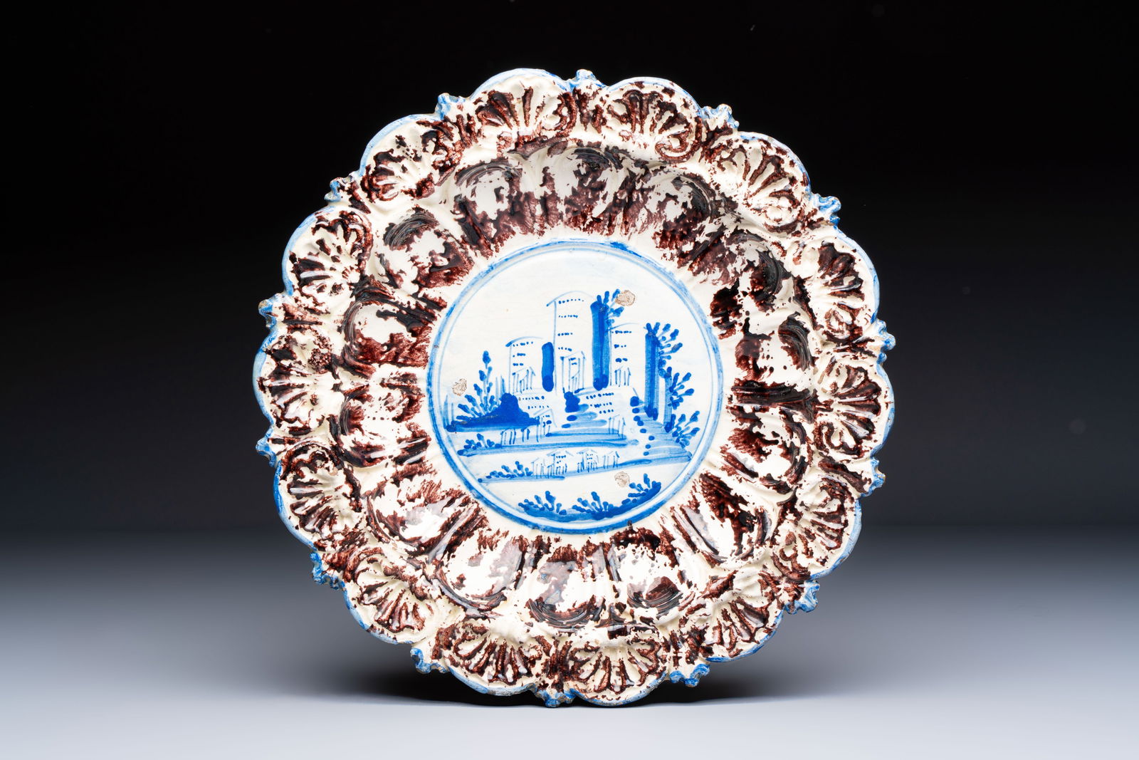 A blue, white and manganese Italian 'Factory' dish, Savona, 17/18th C. (1 of 2)