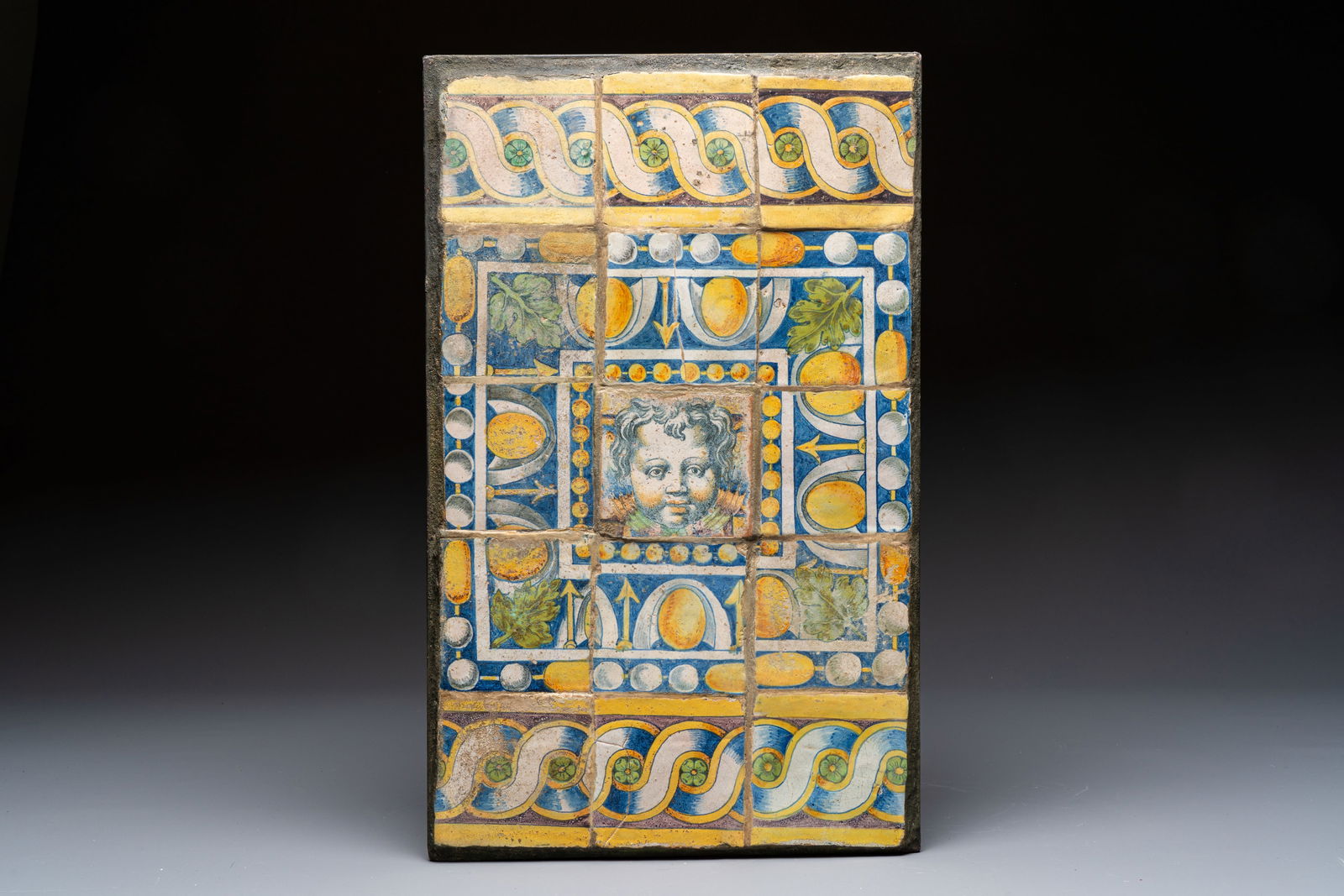 An extremely rare floor tile panel with a cherub head, workshop of Masseot Abaquesne, Rouen, France, (1 of 2)