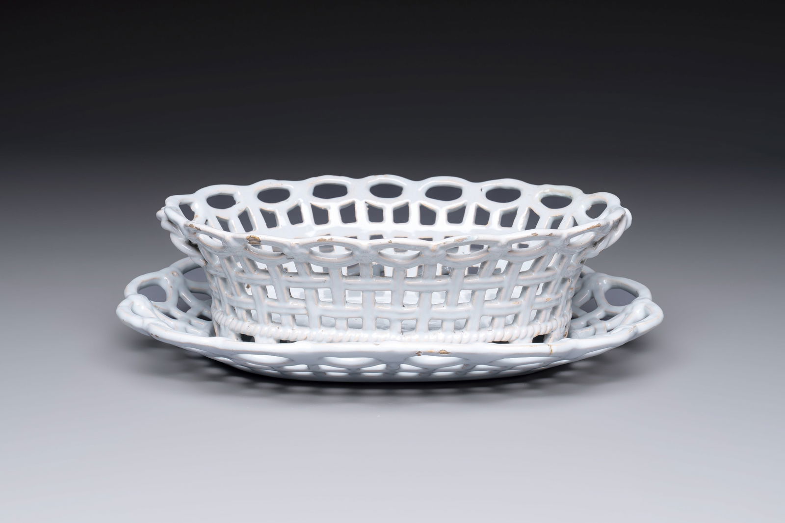 A rare white-glazed Brussels faience reticulated basket on stand, 18th C. (1 of 9)