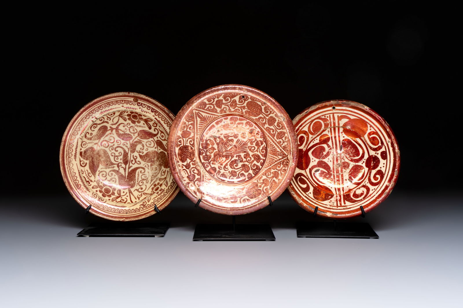 Three Hispano-Moresque lustre-ware plates on later metal stands, Spain, 17/18th C. (1 of 3)