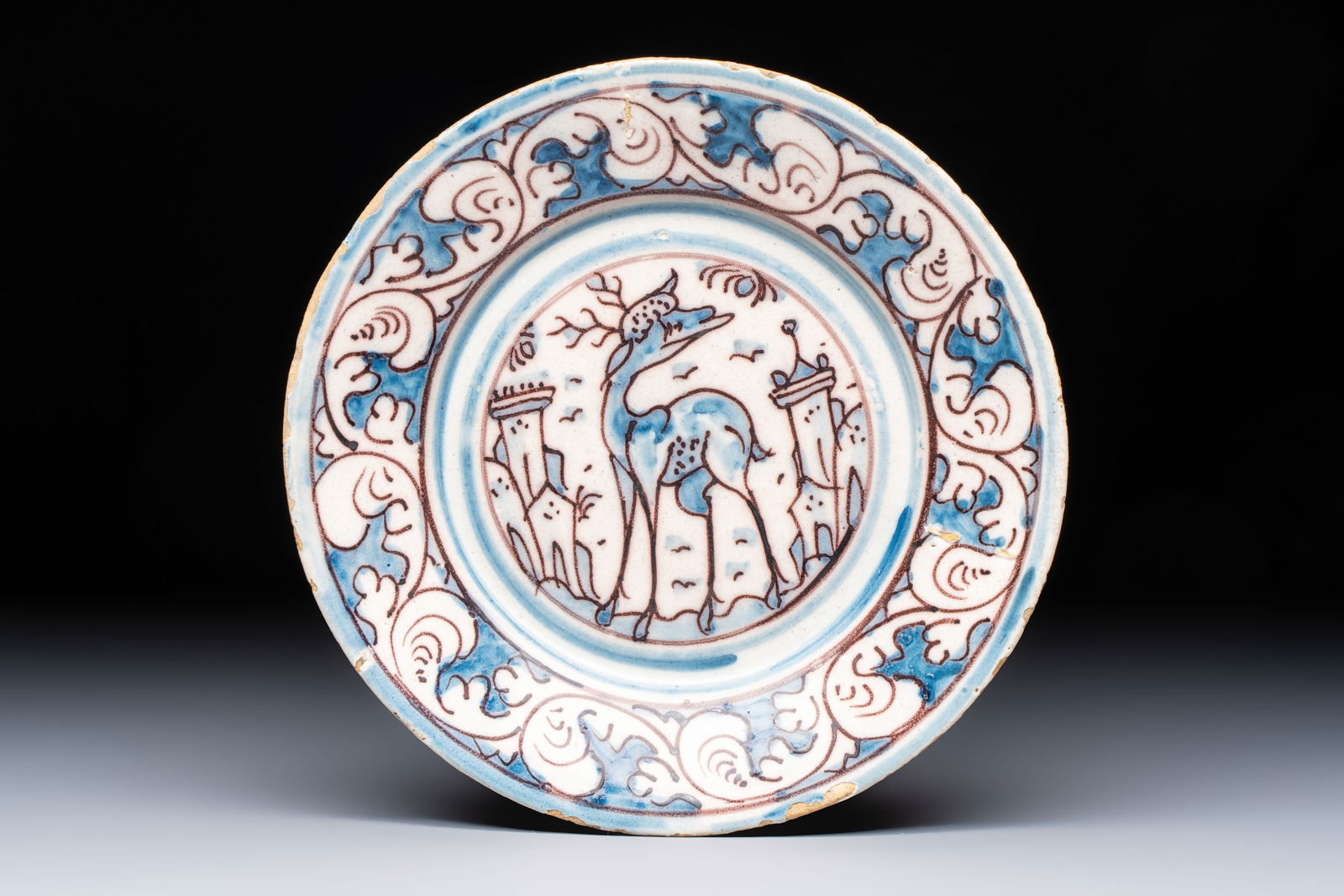 A blue, white and manganese Portuguese 'Deer' plate, 17th C. (1 of 2)