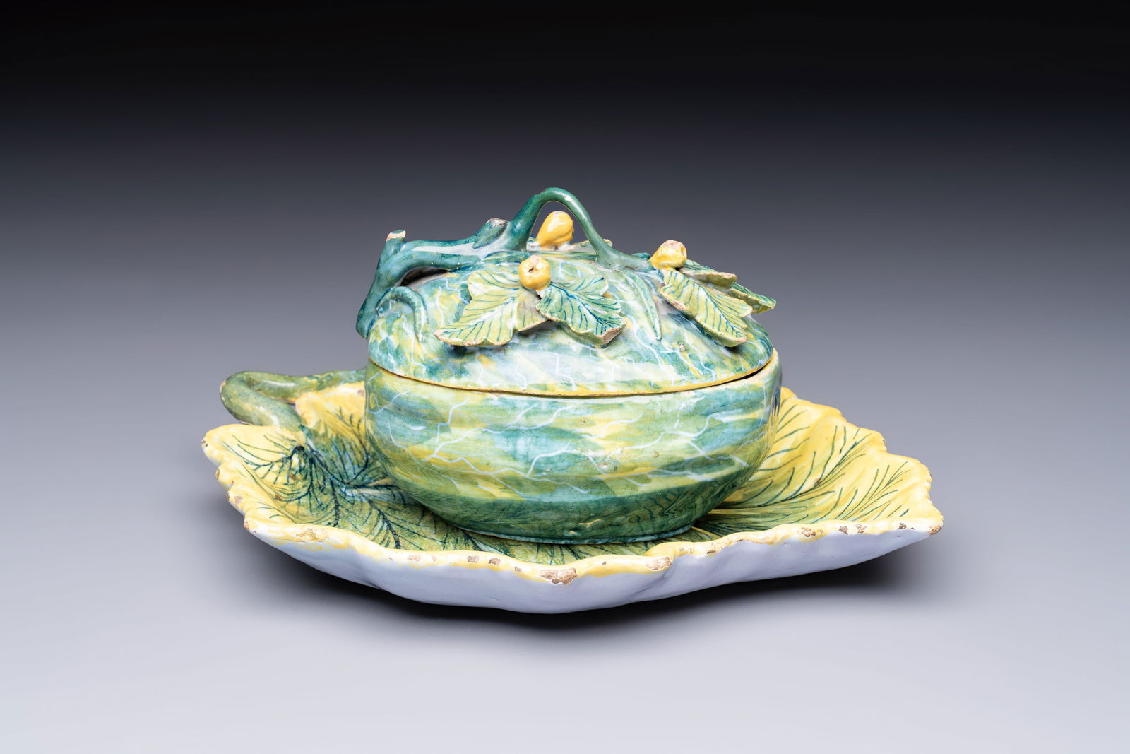 A polychrome Dutch Delft melon-shaped tureen and cover on leaf-shaped stand, 18th C. (1 of 10)