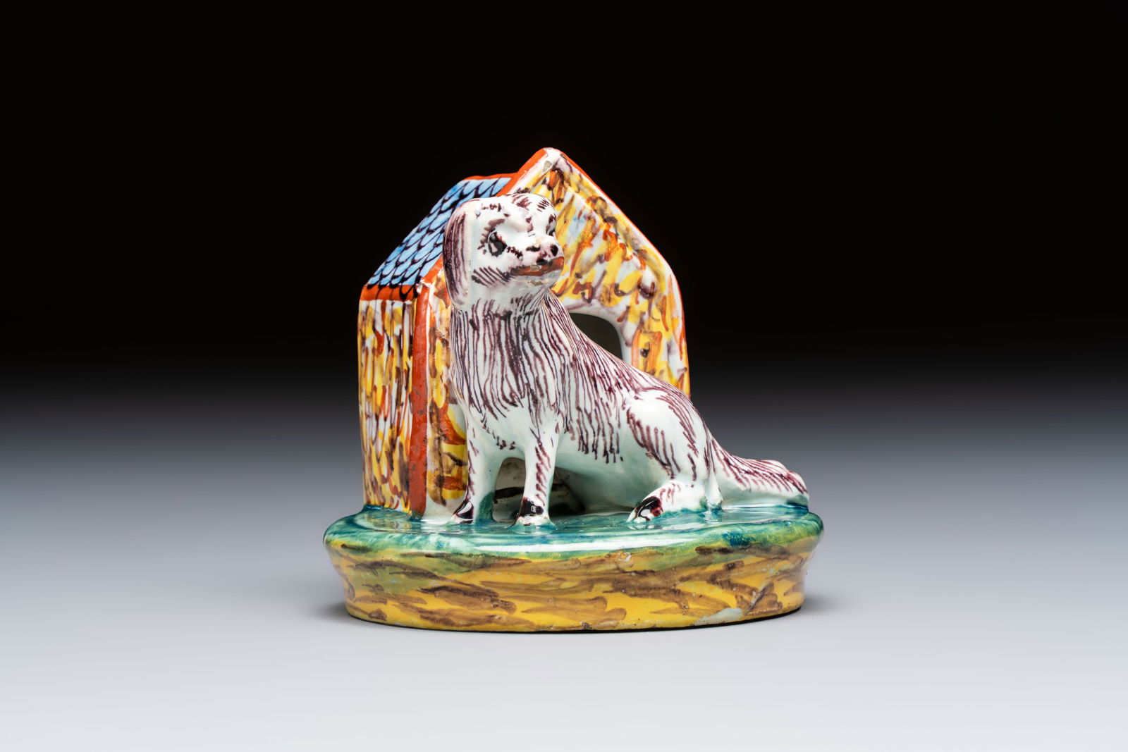 A rare polychrome Dutch Delft sculpture of a dog in front of its kennel, 18th C. (1 of 7)