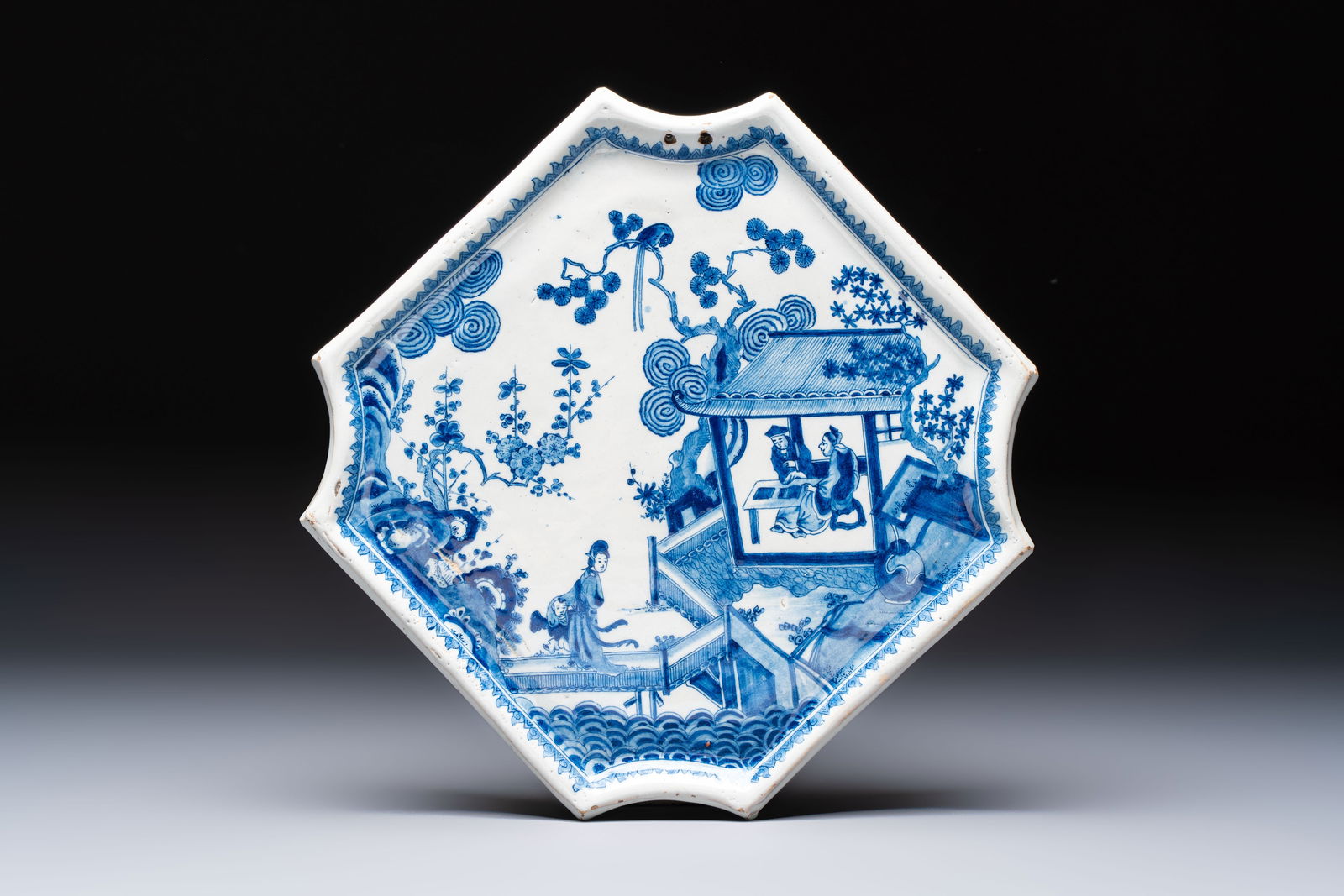 A blue and white Dutch Delft 'Chinoiserie' plaque with figures in garden, 18th C. (1 of 2)