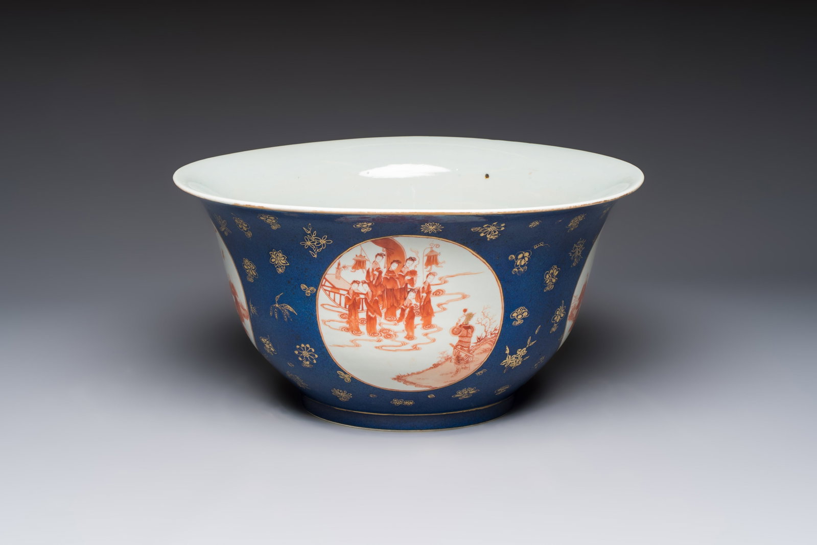 A large Chinese iron-red and gilt-decorated powder-blue-ground bowl with narrative design, 19th C. (1 of 7)