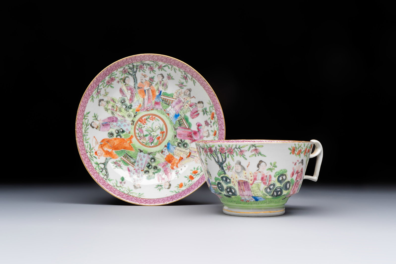 A Chinese Canton famille rose cup and saucer with figures in a garden, 19th C. (1 of 9)