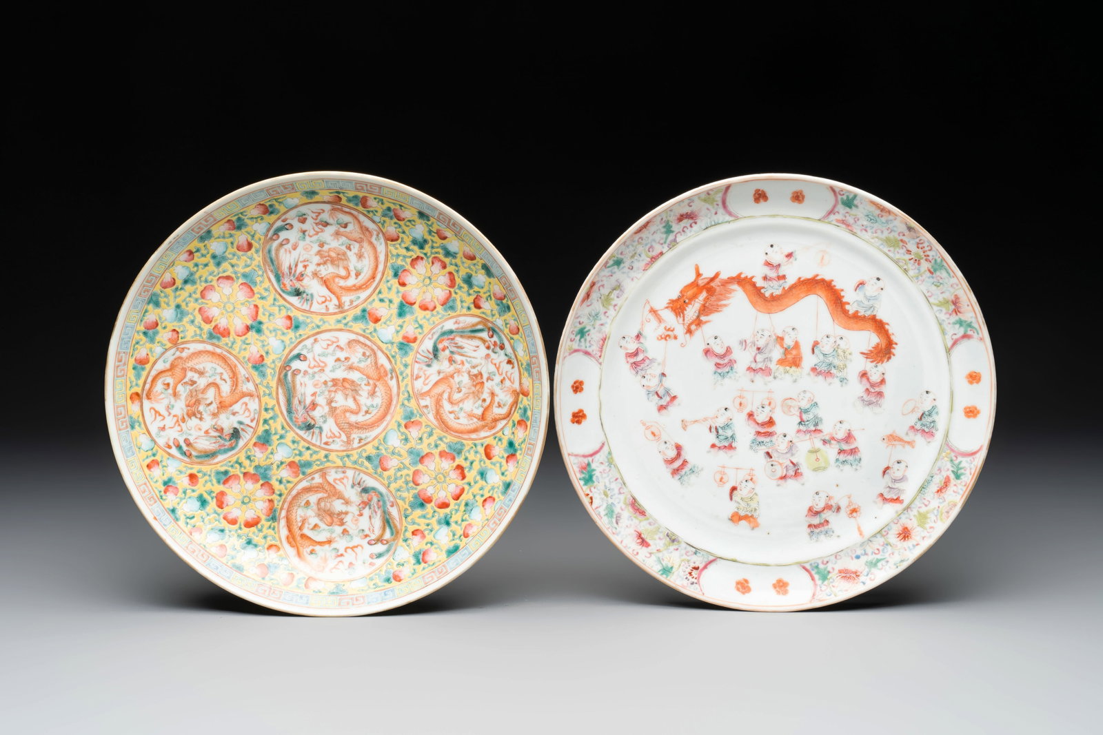 A Chinese famille rose yellow-ground 'dragon' plate and a 'lantern festival' plate, Guangxu marks: A Chinese famille rose yellow-ground 'dragon' plate and a 'lantern festival' plate, Guangxu marks and of the period Dia.: 24,3 cm