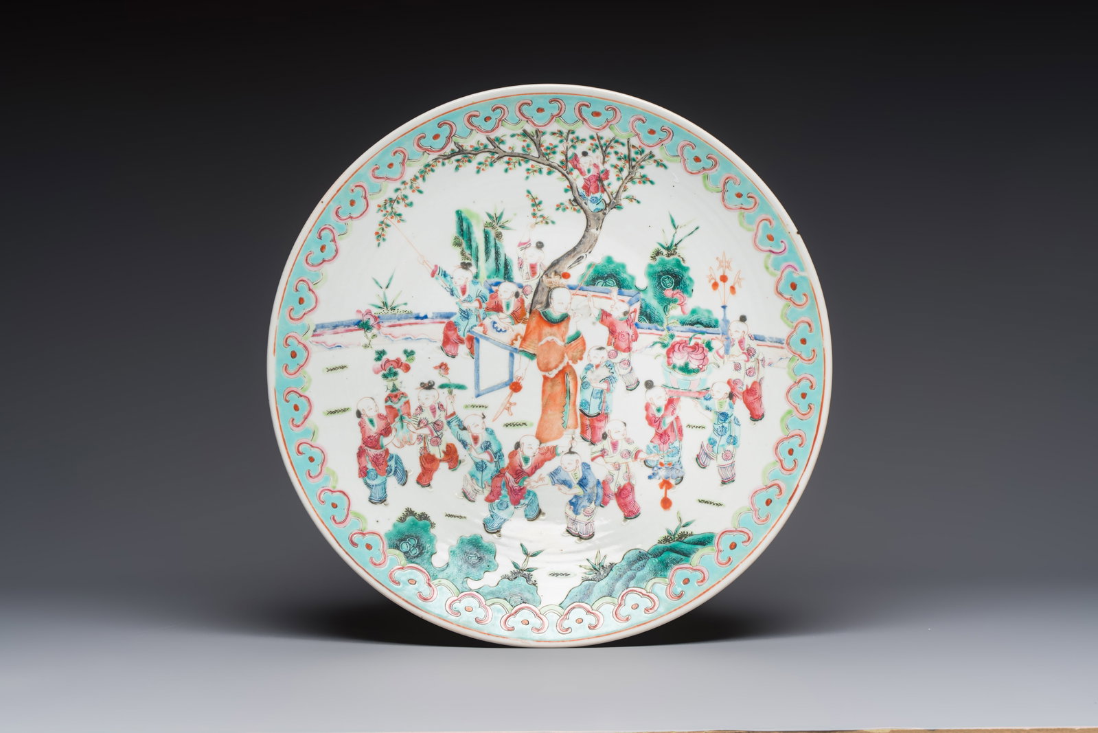 A large Chinese famille rose '100 boys' dish, 19th C. (1 of 2)