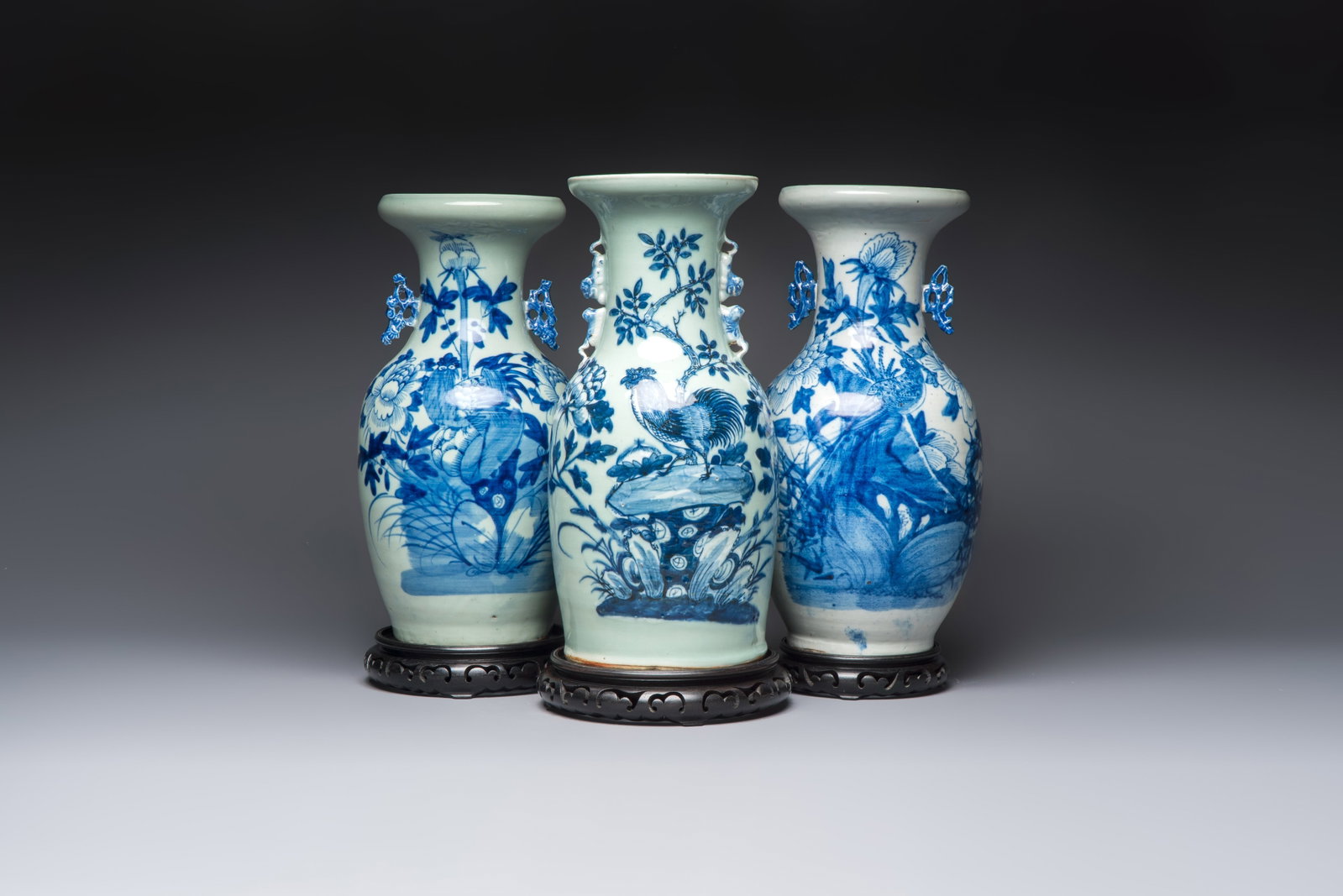 Two Chinese blue and white celadon-ground vases and a blue and white vase, on wooden stands, 19th C. (1 of 7)