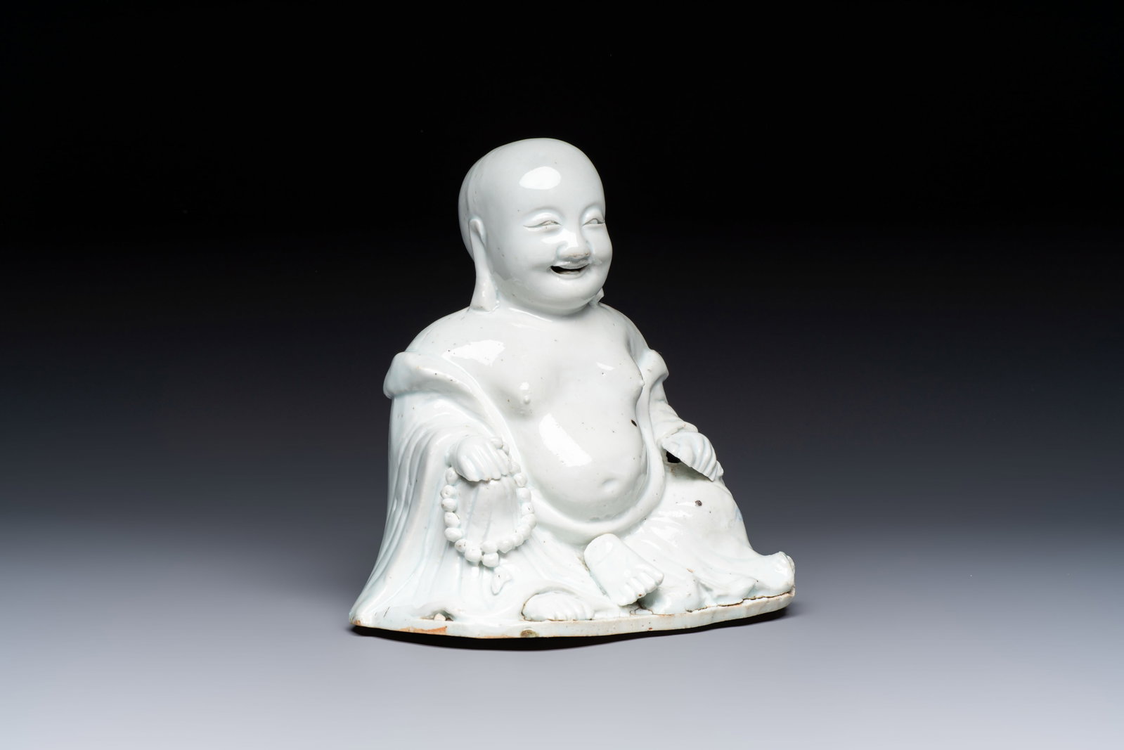 A Chinese white-glazed Milefo Buddha, 19th C. (1 of 7)
