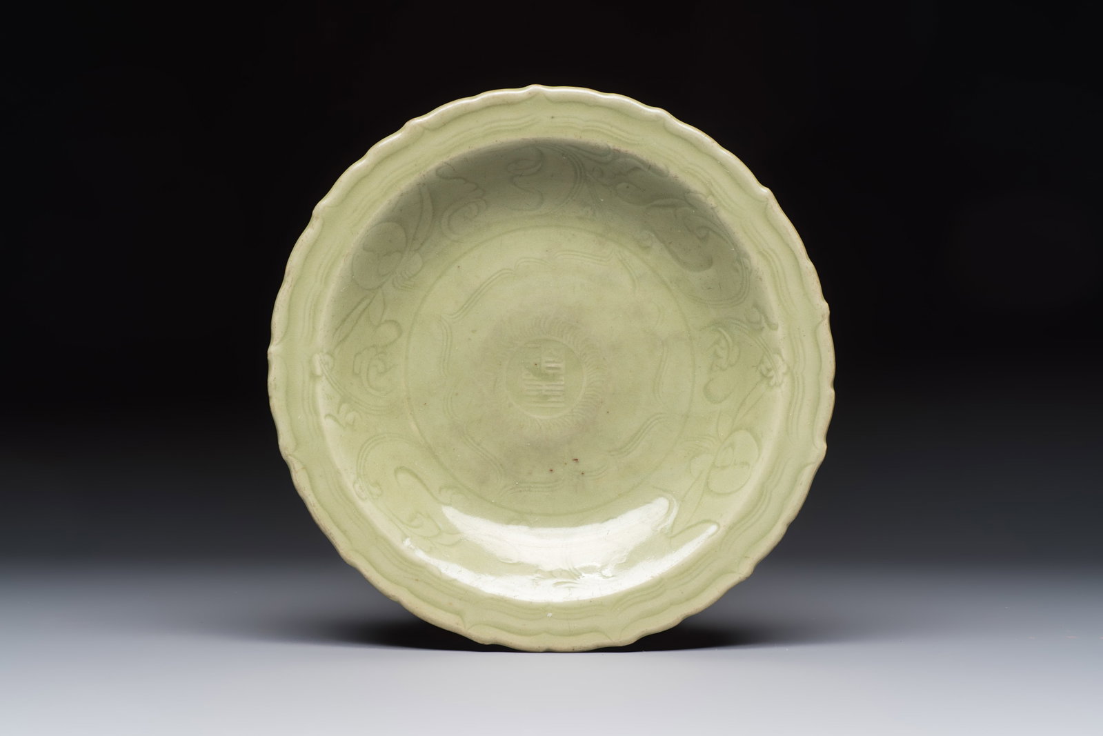 A Chinese Longquan celadon inscribed dish with incised floral design, Ming (1 of 2)