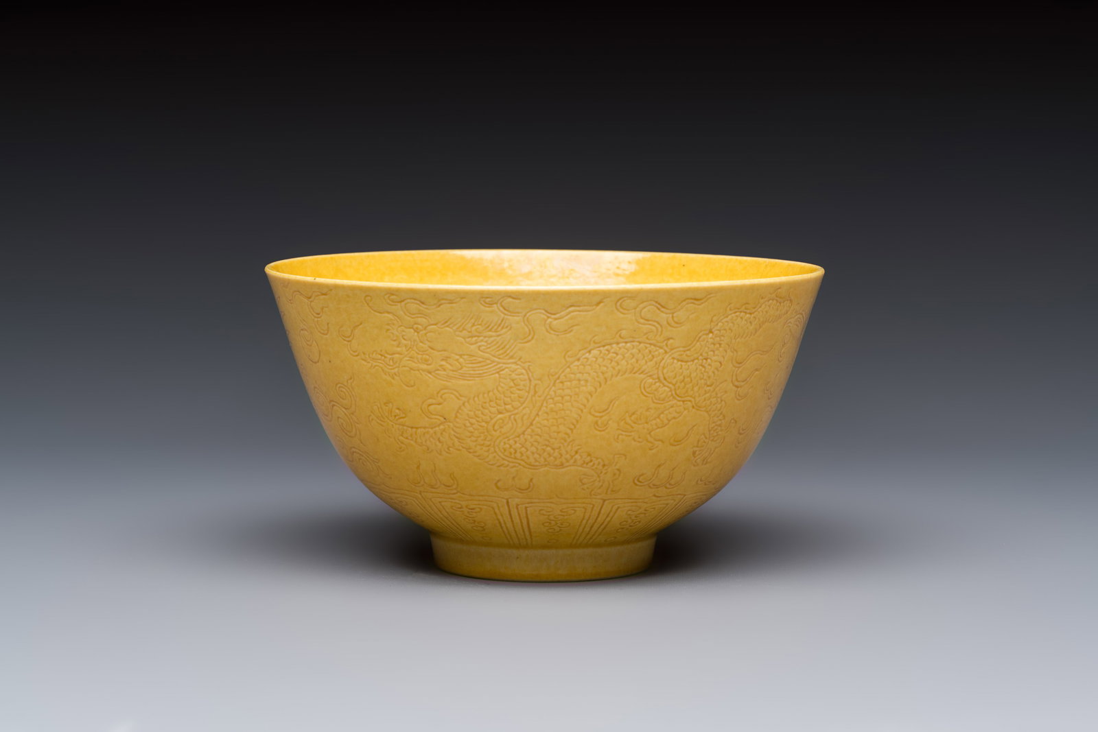 A Chinese yellow-glazed incised 'Dragon and Phoenix' bowl, Xianfeng mark and of the period: A Chinese yellow-glazed incised 'Dragon and Phoenix' bowl, Xianfeng mark and of the period Dia.: 11,2 cm - H.: 6 cm Ref.:Sotheby's Hong Kong, 18 November - 4 December 2024, lot 9354 for an identical p