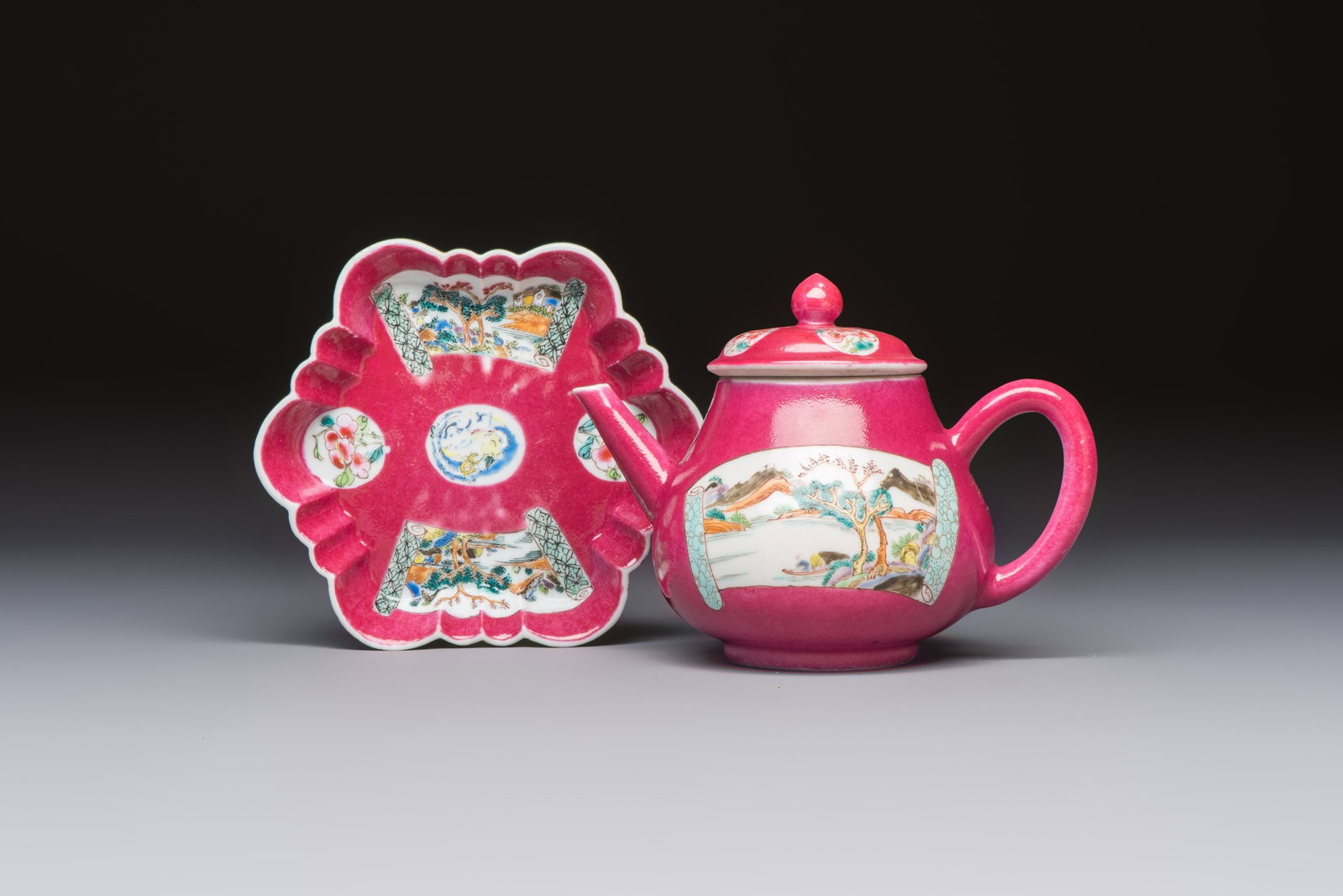 A Chinese famille rose ruby-ground 'Landscape Scroll' teapot and stand, Yongzheng (1 of 9)