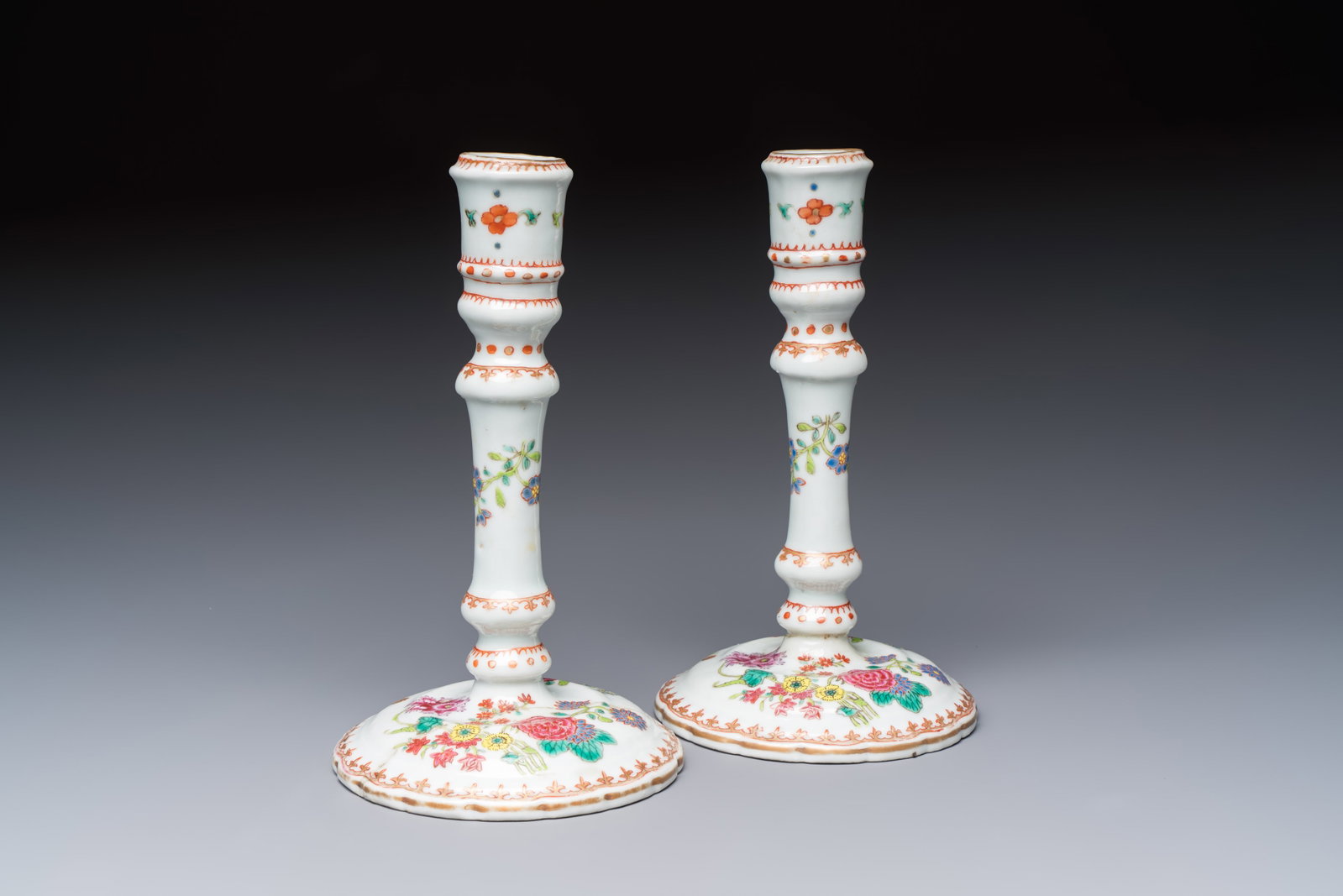 A pair of Chinese famille rose candlesticks with floral design, Qianlong: A pair of Chinese famille rose candlesticks with floral design, Qianlong H.: 20 cm