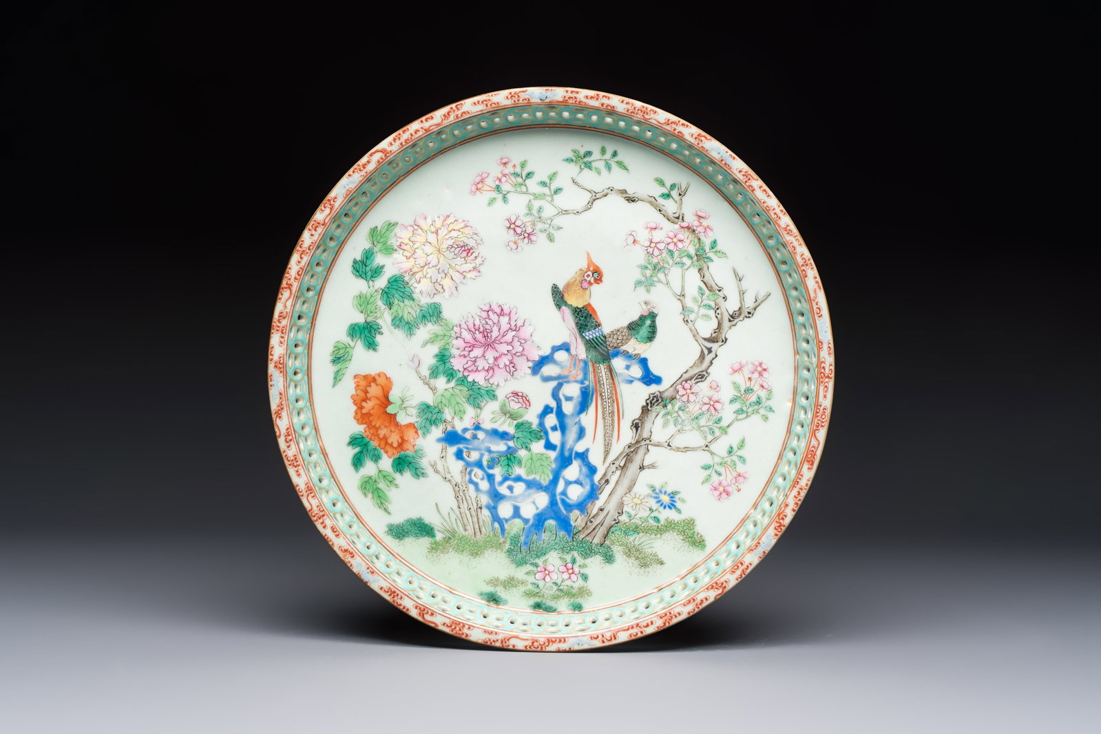 A fine Chinese famille rose pale celadon-ground 'phoenixes' dish with a reticulated rim, Qianlong (1 of 2)