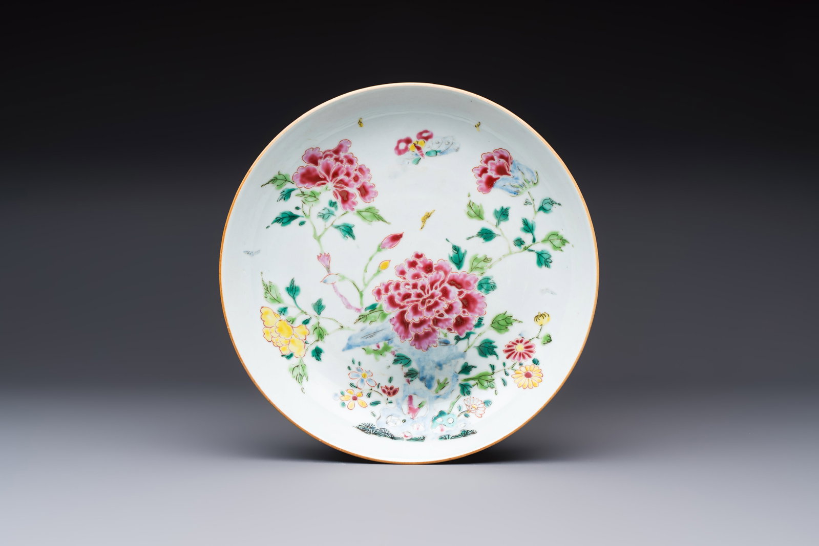 A Chinese famille rose 'Peonies' plate, Yongzheng/Qianlong (1 of 2)