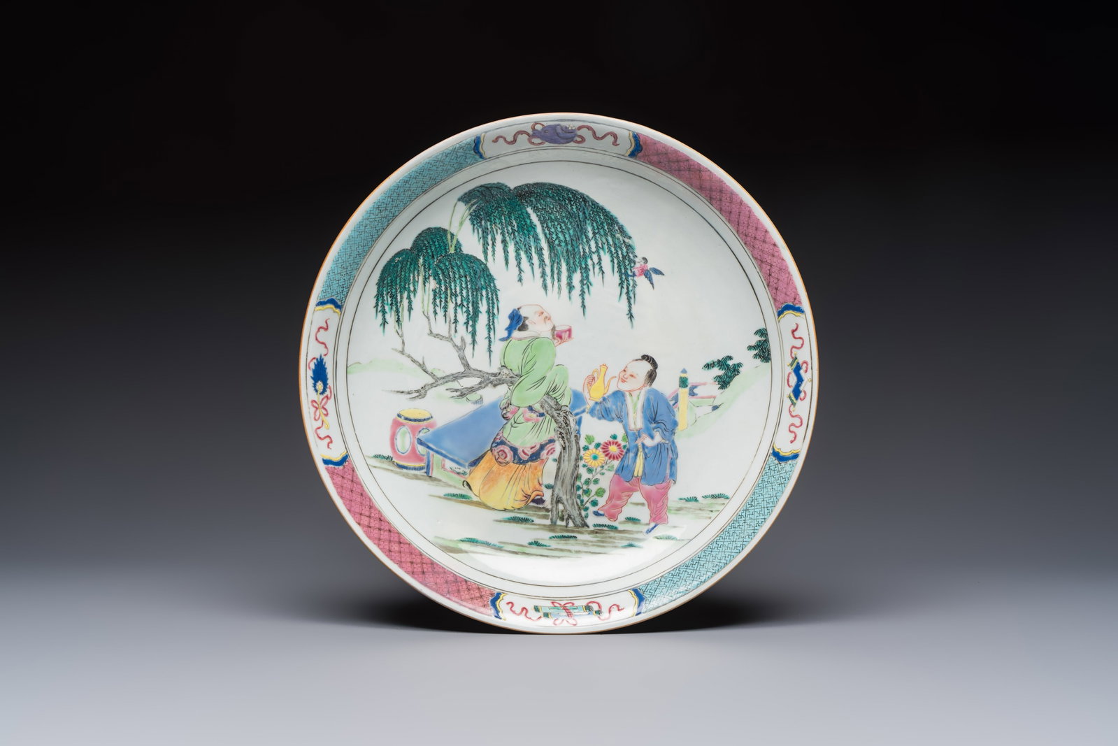 A Chinese famille rose 'Wine Drinking Sage and Attendant' dish, Yongzheng (1 of 2)