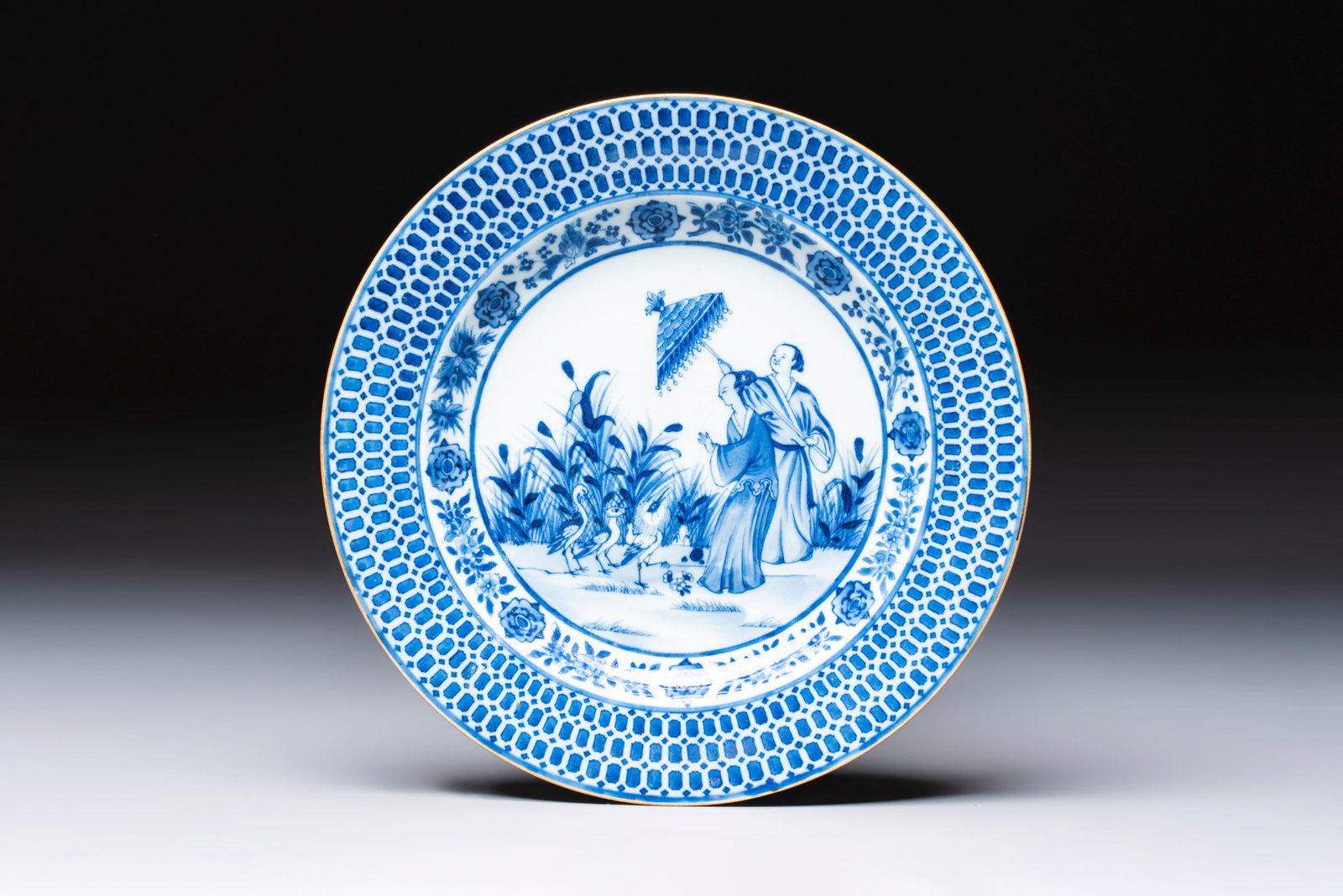 A Chinese blue and white 'La Dame au Parasol' plate after Cornelis Pronk, Qianlong: A Chinese blue and white 'La Dame au Parasol' plate after Cornelis Pronk, Qianlong Dia.: 22,2 cm Provenance: - A private French collection. Ref.: - Christie's New York, 20 January 2021, lot 25 for a c