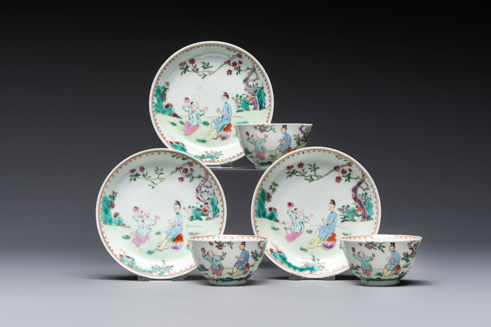 Three sets of Chinese famille rose 'Elegant Beauty and Boy' cups and saucers, Qianlong: Three sets of Chinese famille rose 'Elegant Beauty and Boy' cups and saucers, Qianlong Dia.: 11,9 cm (the saucers) Dia.: 7,4 cm - H.: 4,2 cm (the cups)