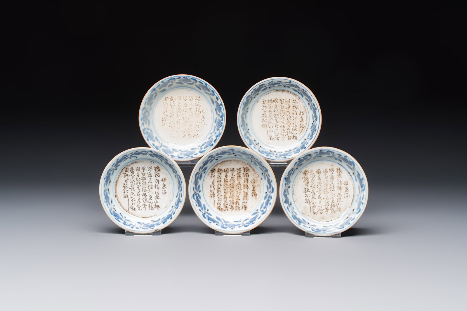 Five Japanese blue and white saucer dishes with an incised poem, Edo, 18th C. (1 of 5)