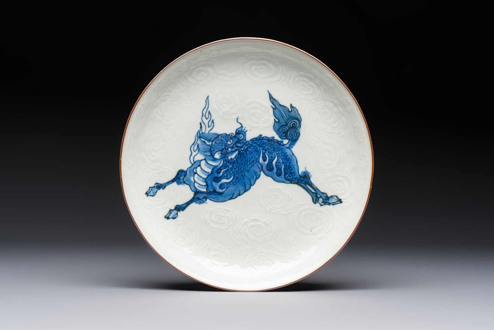 A Japanese Arita blue and white Kakiemon-style 'Kirin' plate with underglaze relief design, Edo, (1 of 2)