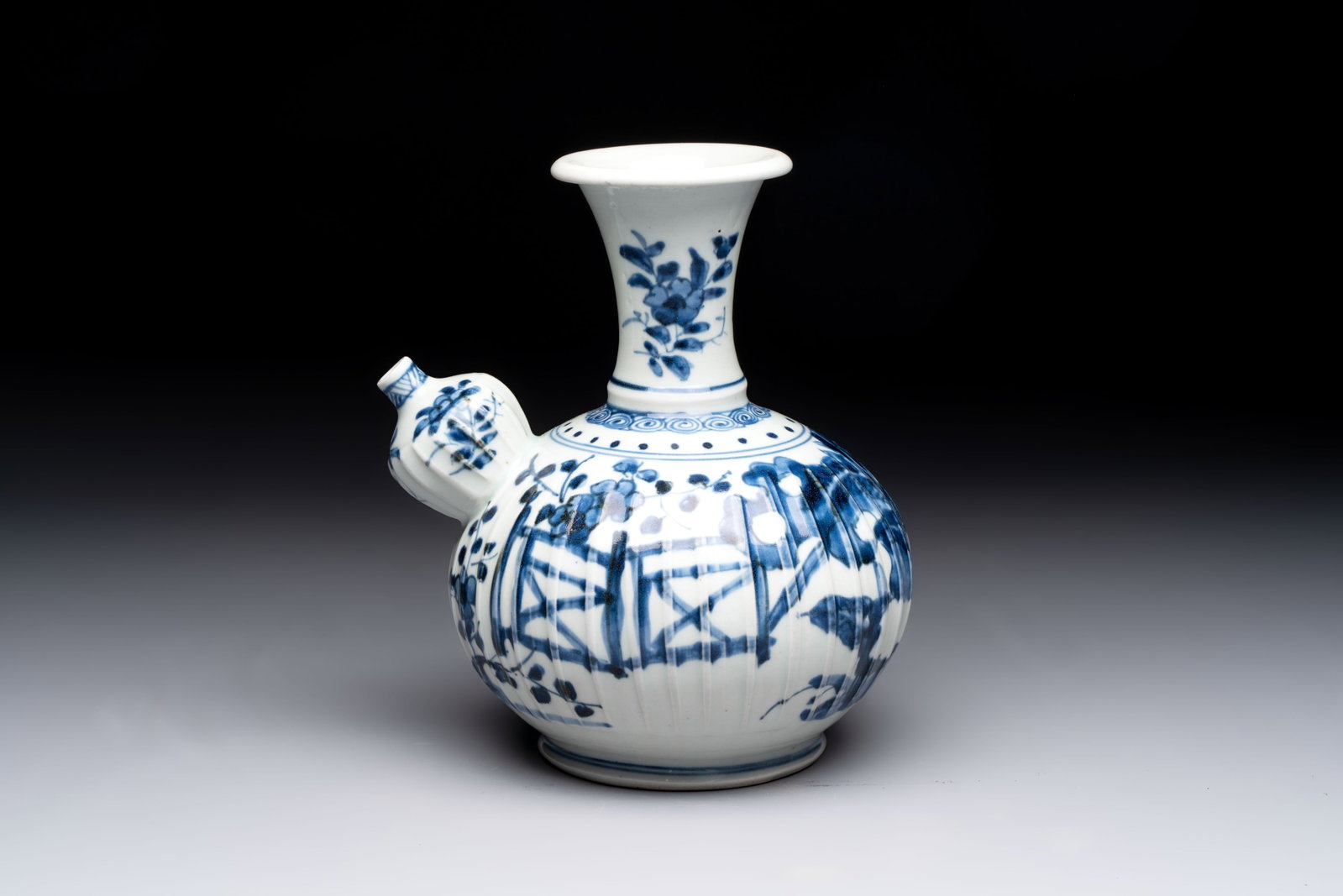 A Japanese blue and white kendi with a garden scene, Edo, early 18th C.: A Japanese blue and white kendi with a garden scene, Edo, early 18th C. L.: 18 cm - H.: 20,5 cm
