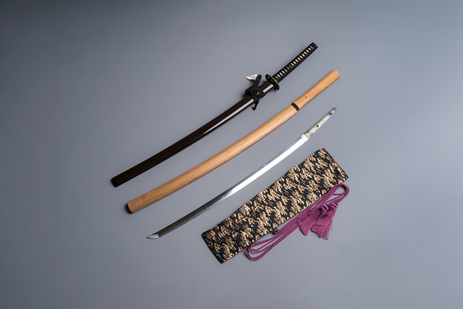 A Japanese katana, signed Ishido Teruhide saku, with koshirae and shirasaya, Showa, 20th C.: A Japanese katana, signed Ishido Teruhide saku, with koshirae and shirasaya, Showa, 20th C. L.: 99 cm (koshirae) L.: 88,9 cm (nagasa) L.: 2,1 cm (saki-haba) L.: 3,2 cm (moto-haba)