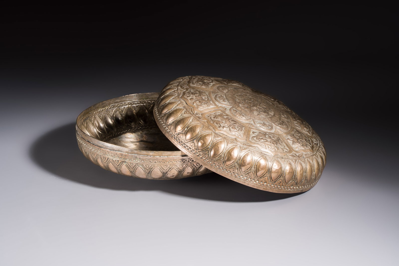 A Malay silver circular betel box and cover with floral design, 19th C. (1 of 7)