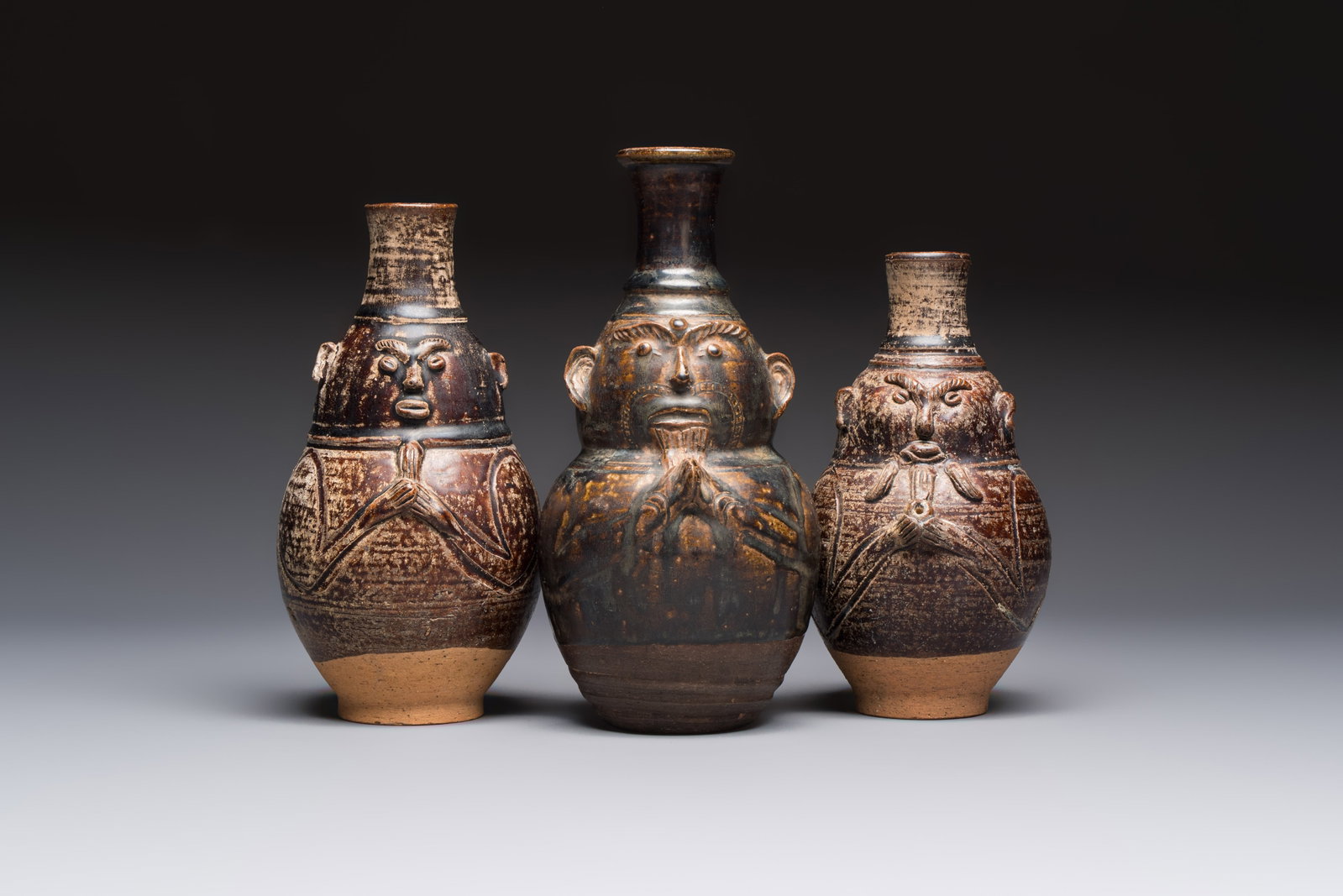 Three khmer-style brown-glazed anthropomorphic gourd-form bottles, probably 12/13th C. (1 of 7)