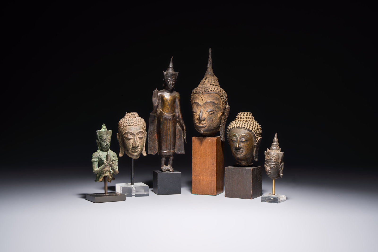 A bronze standing Buddha, a torso of Buddha and four heads of Buddha, Thailand, 17/18th C. (1 of 13)