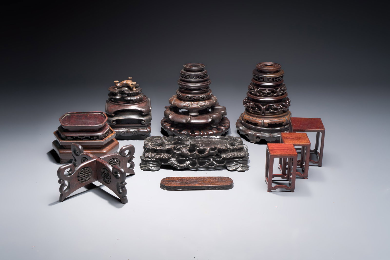 A collection of 25 Chinese wooden stands, 19/20th C. (1 of 4)