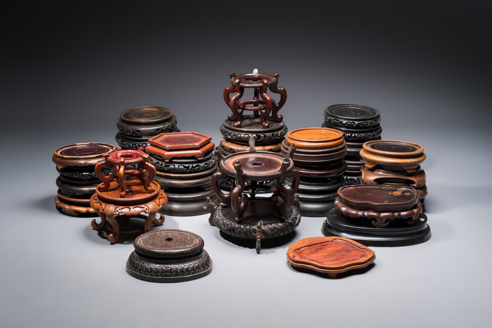 A collection of 40 mainly Chinese wooden stands, 19/20th C. (1 of 4)