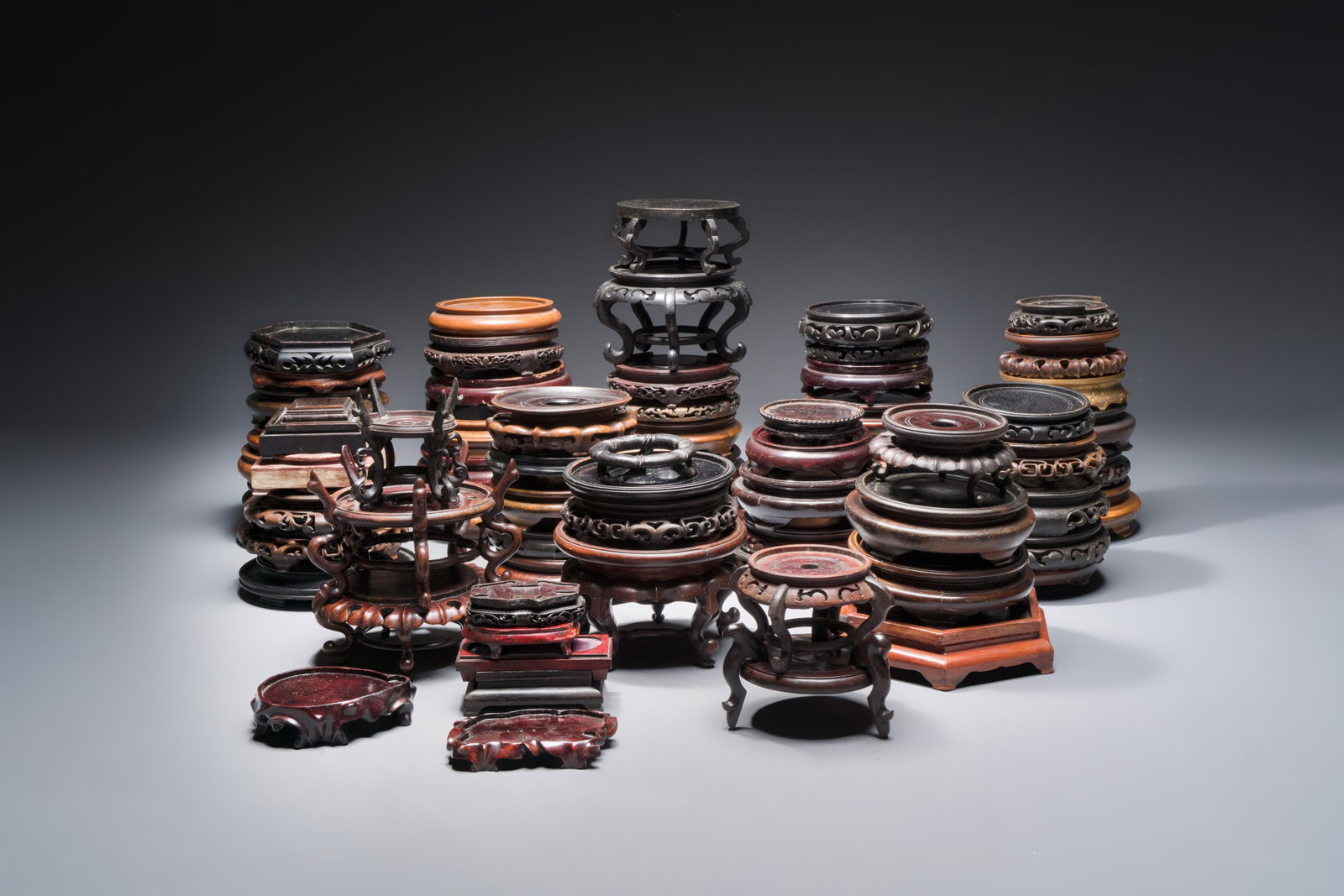 A collection of 70 Chinese wooden stands, 19/20th C. (1 of 4)
