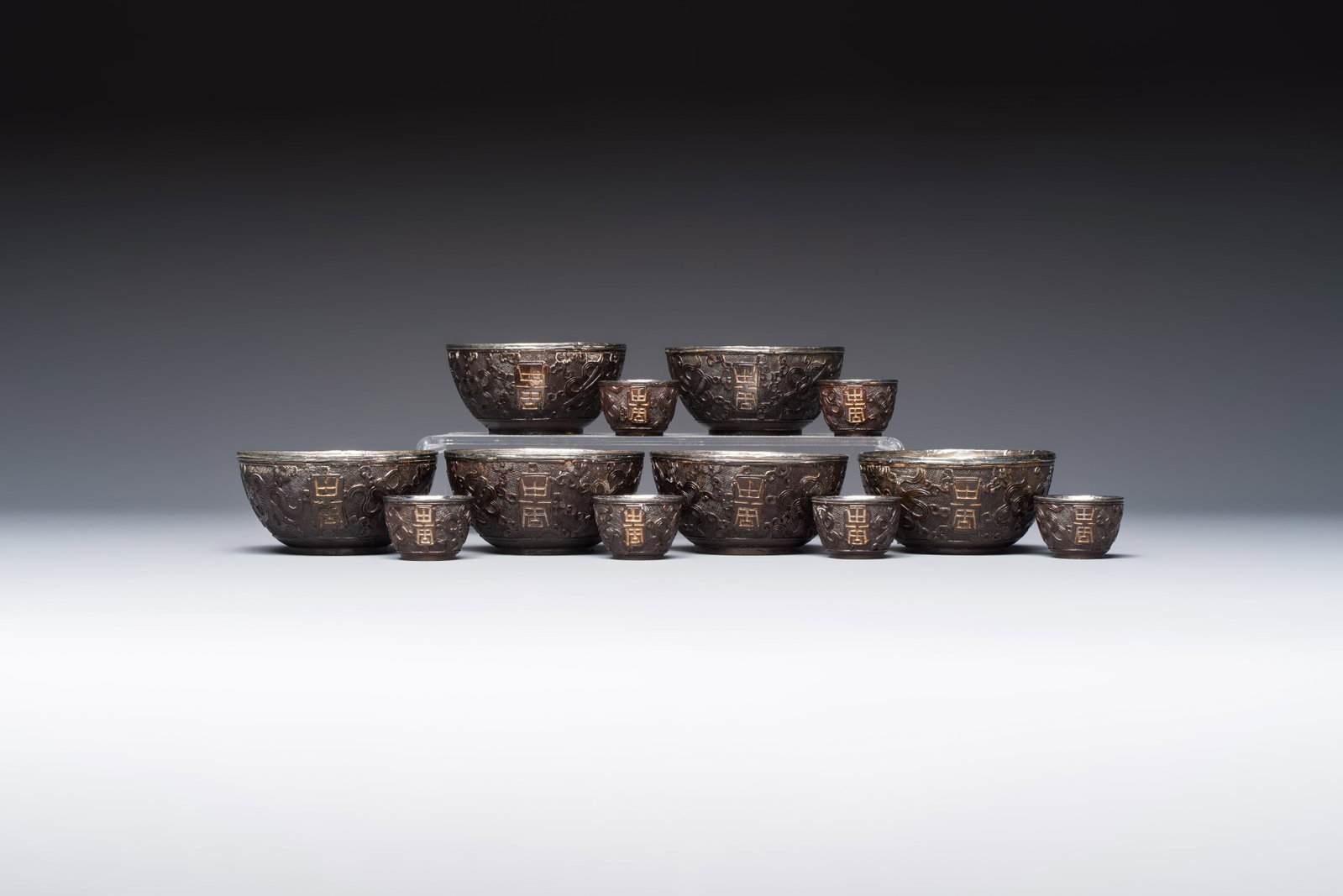 A group of 12 Chinese silver-lined coconut 'Shou' bowls and cups, Wang Hengxin marks, 19/20th C. (1 of 19)