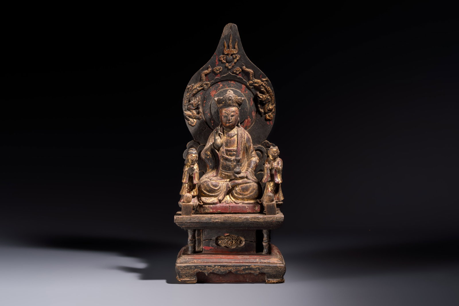 A Chinese gilt-lacquered wooden Bodhisattva and attendants on a throne, Qing (1 of 7)