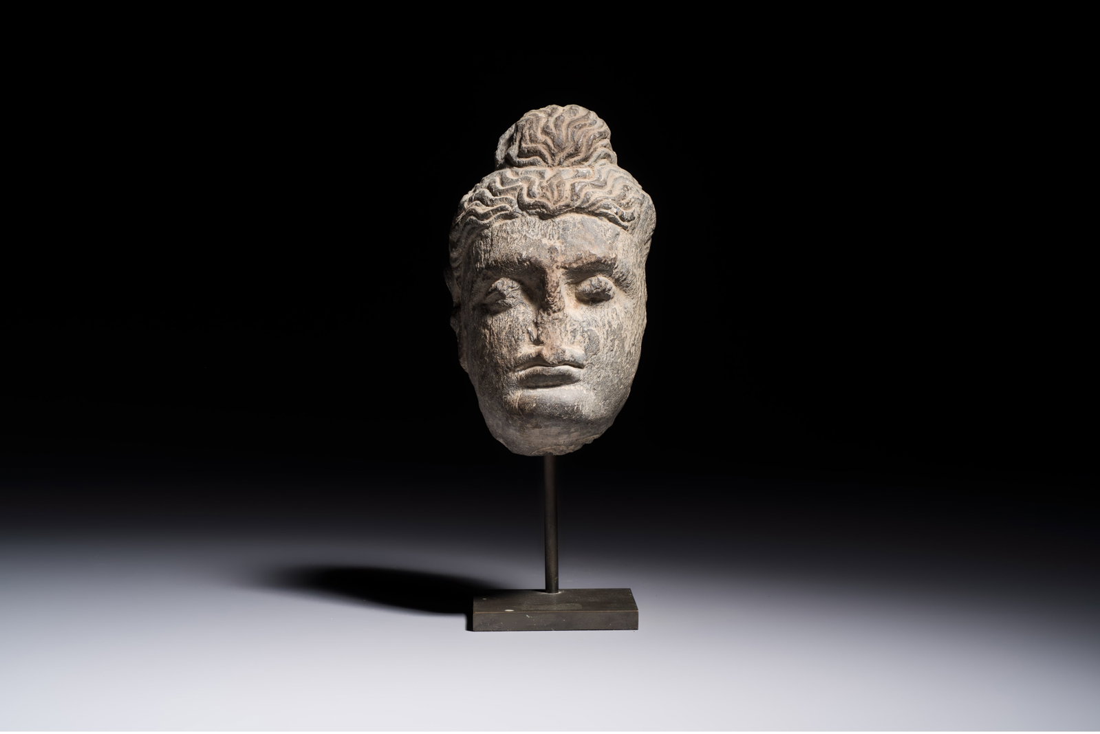 A Gandhara grey schist relief fragment of a Bodhisattva head, 3rd/4th C. (1 of 7)
