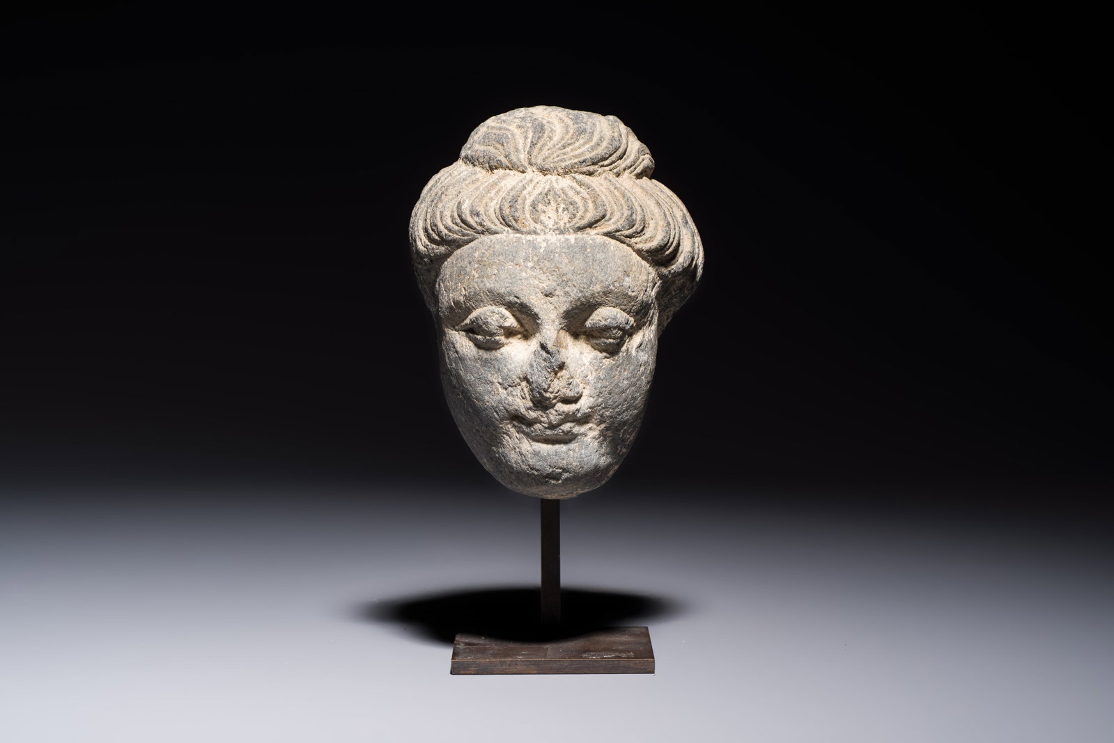 A Gandhara grey schist relief fragment of a Bodhisattva head, 3rd/4th C. (1 of 7)