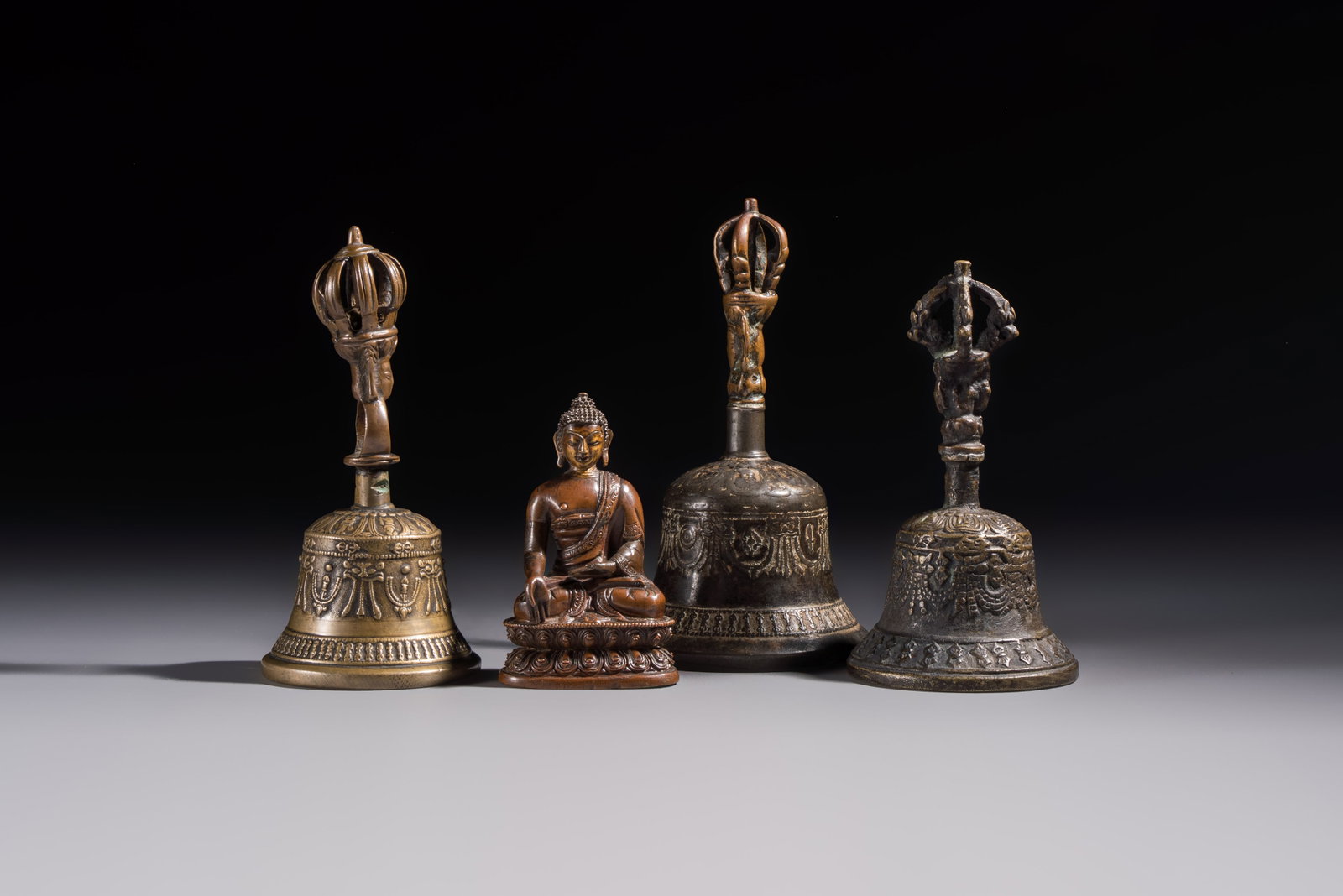 Three Tibetan bronze ritual bells and a bronze Buddha, 19th C. (1 of 13)