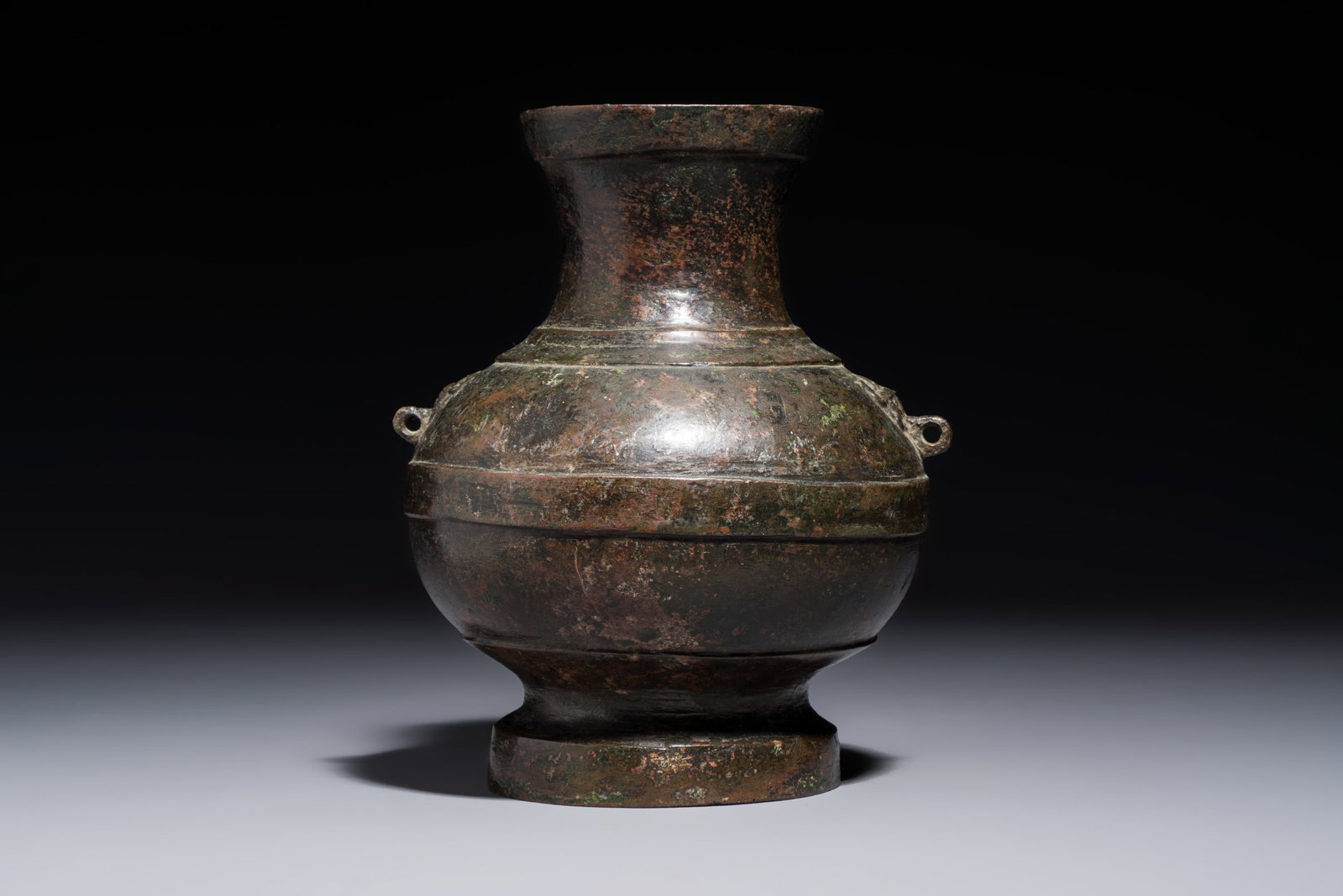 A miniature Chinese archaic bronze wine vessel with Taotie handles, 'Hu', Han (1 of 7)