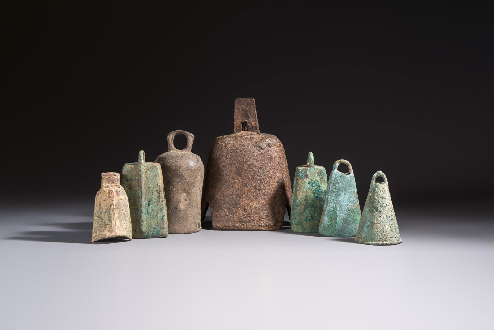 Seven various Chinese bronze and cast-iron bells, Han and later (1 of 19)