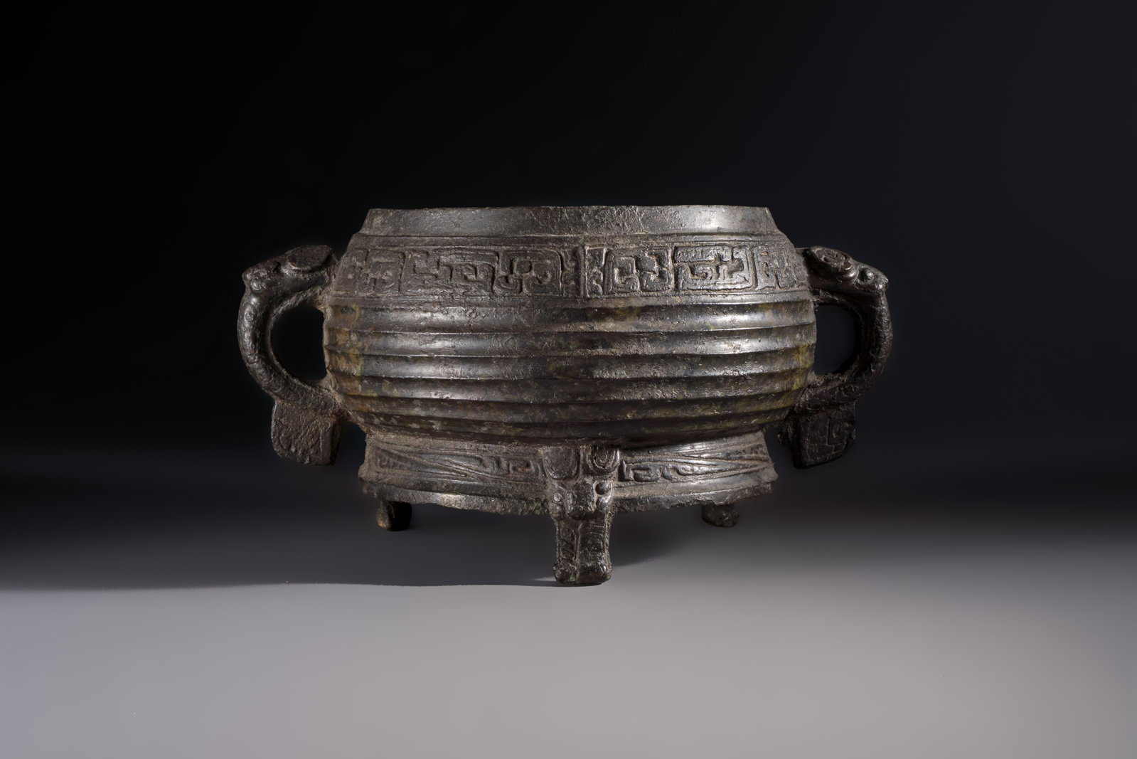 A Chinese archaic ritual tripod food vessel with Taotie design, 'Gui', Western Zhou (1 of 6)