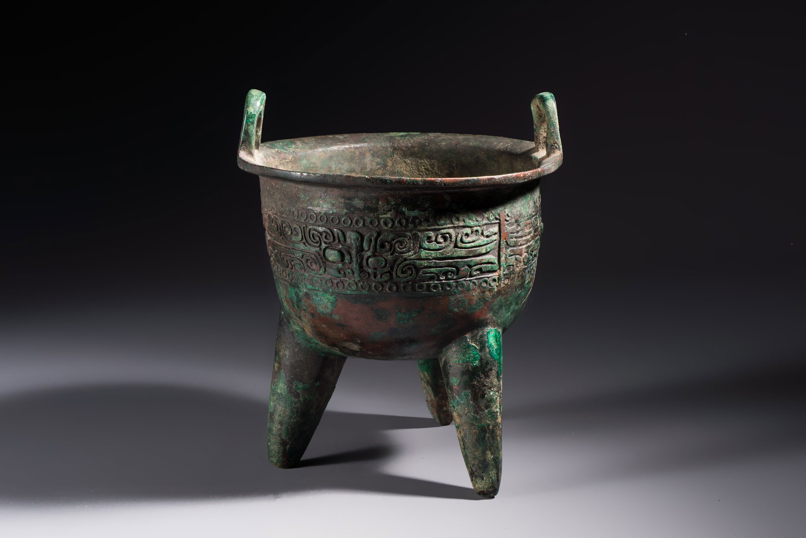 A Chinese archaic bronze ritual tripod food vessel, 'Li', early Shang (1 of 7)
