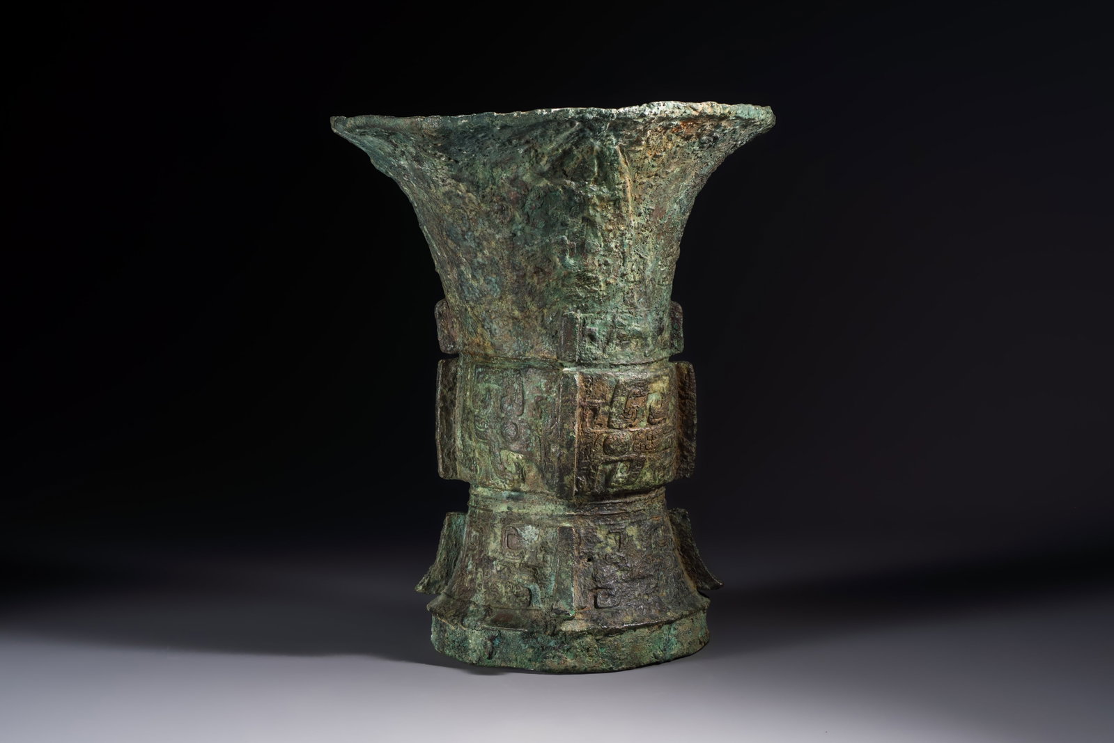 A Chinese archaic bronze ritual wine vessel with Taotie design, 'Zun', Shang (1 of 6)