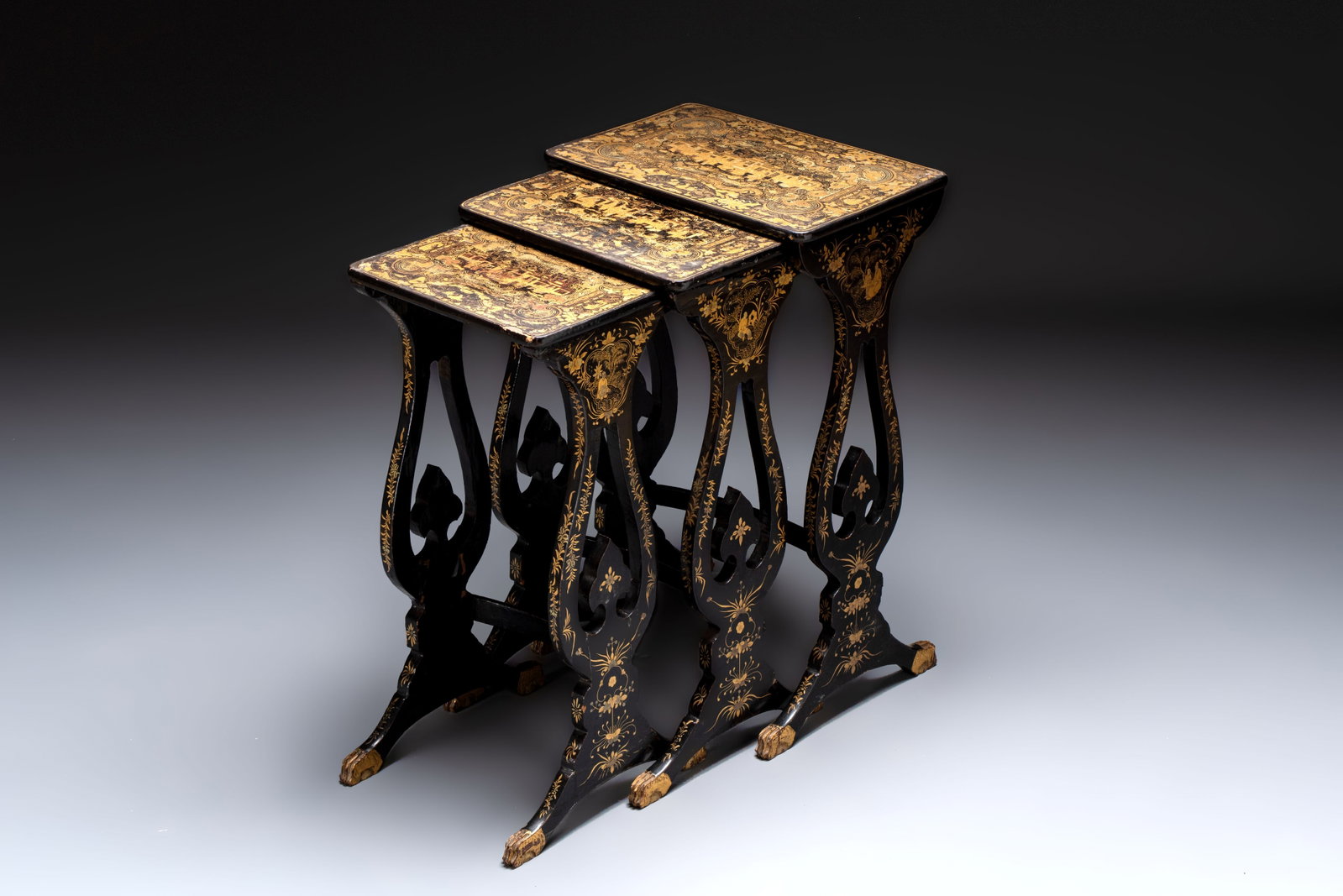 A set of three Chinese Canton gilt-lacquered nesting tables with narrative design, 19th C. (1 of 8)