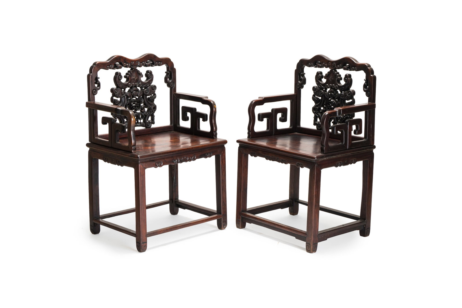 A pair of Chinese carved hongmu armchairs, 19th C. (1 of 8)