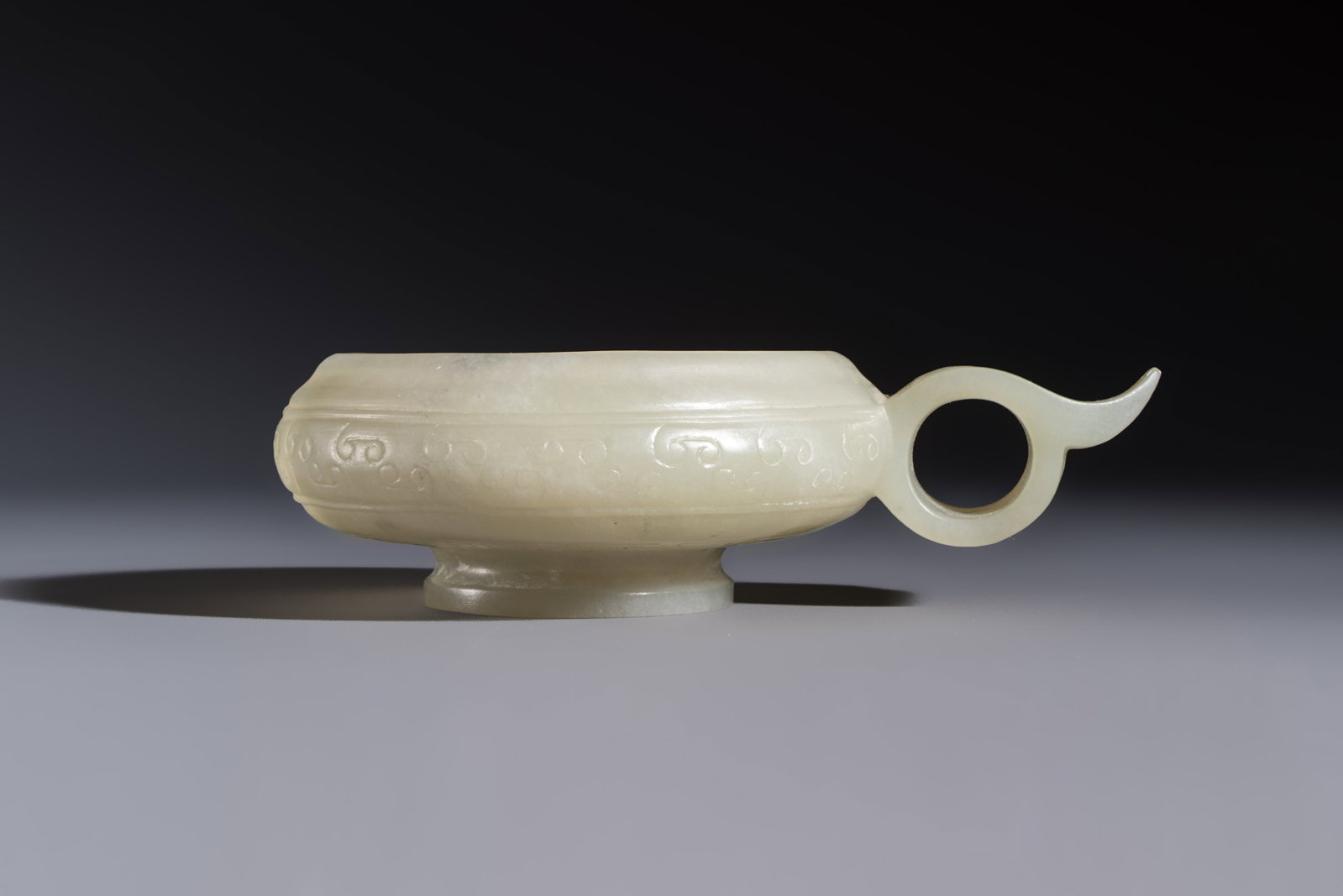 A Chinese archaistic celadon jade handled cup, 'Yi', 17/18th C. (1 of 7)