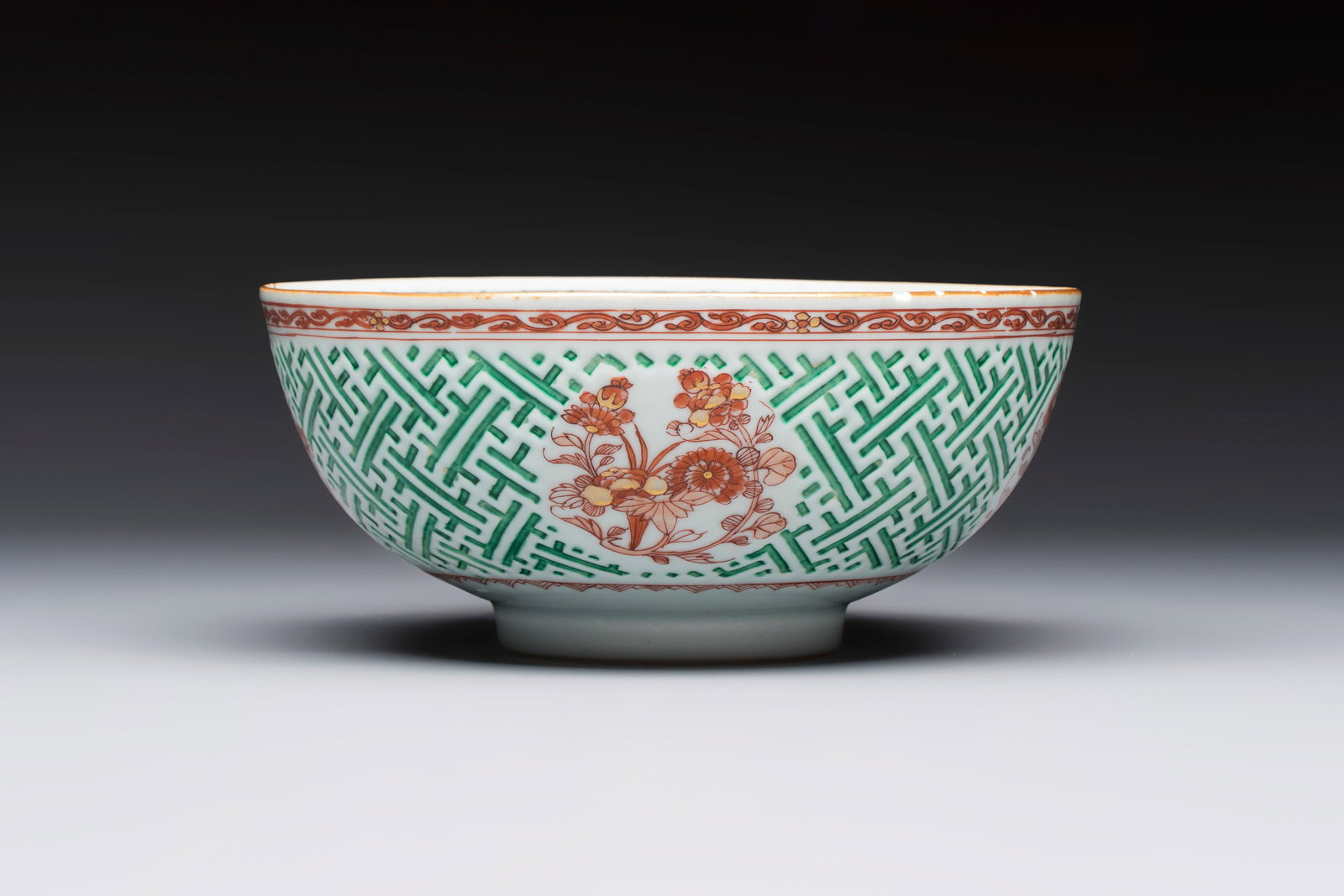 A Chinese famille verte relief-carved bowl with gilt iron-red floral design, Kangxi (1 of 6)