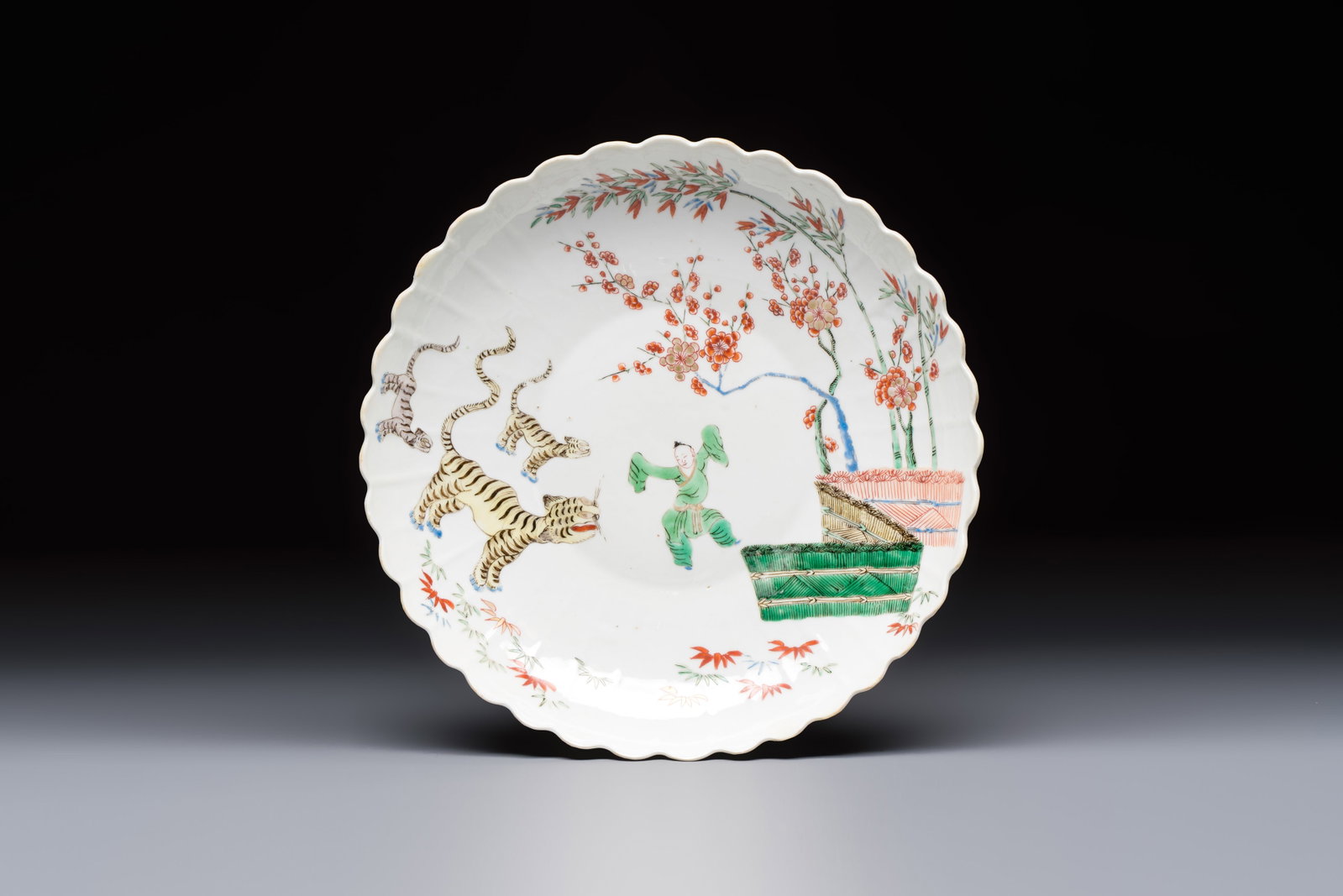 A Chinese famille verte Kakiemon-style 'Boy and Tigers' lobed dish, Kangxi (1 of 2)